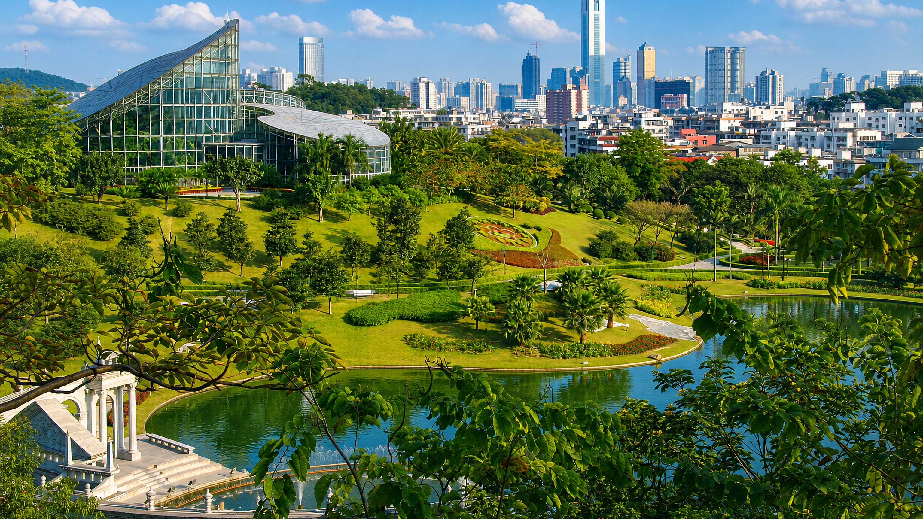 Yuntai Garden's lake and glass conservatory in Baiyun District with the Guangzhou skyline behind.