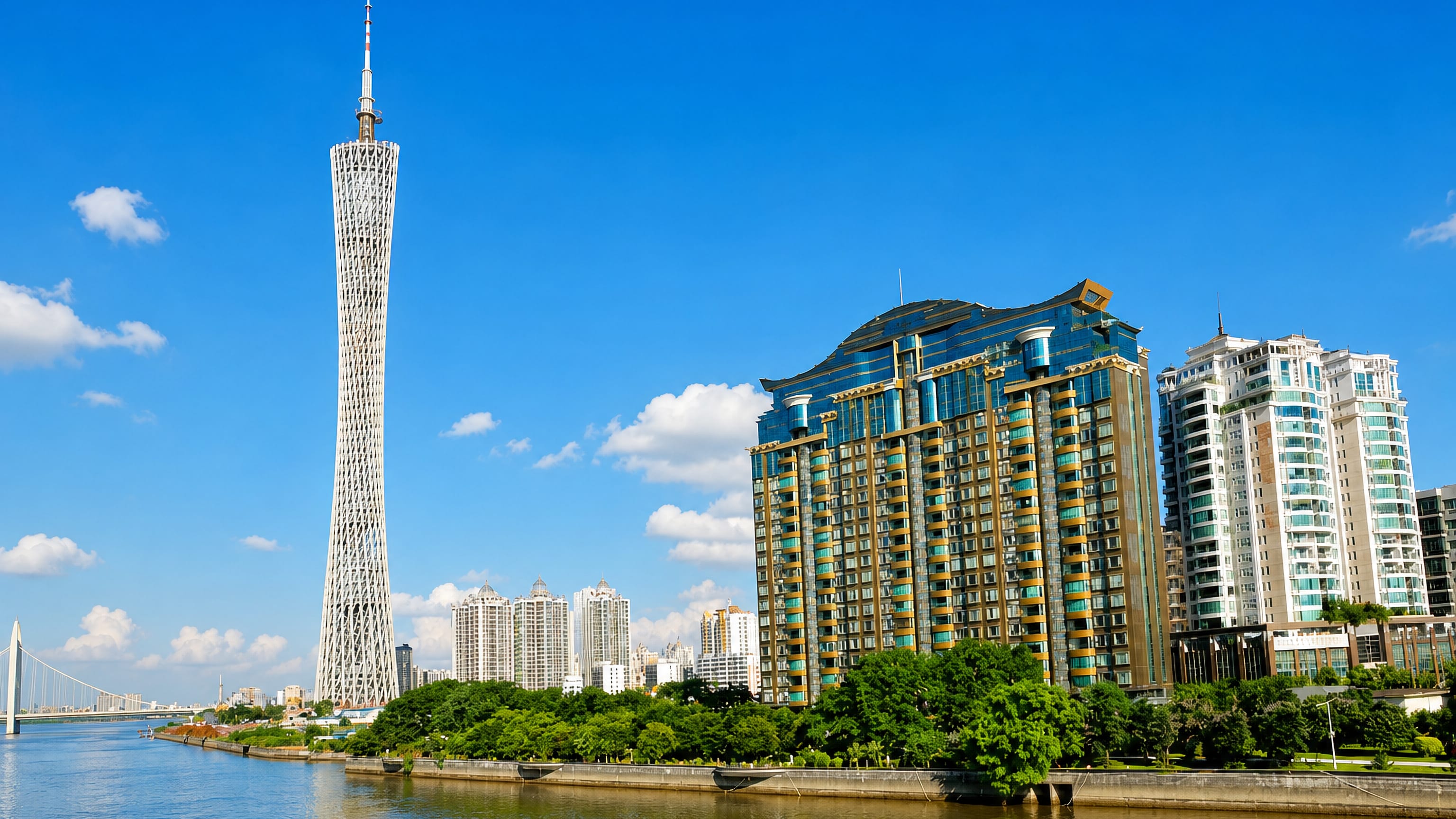 Canton Tower rising above the Pearl River waterfront and riverside high-rises in Haizhu District, Guangzhou.