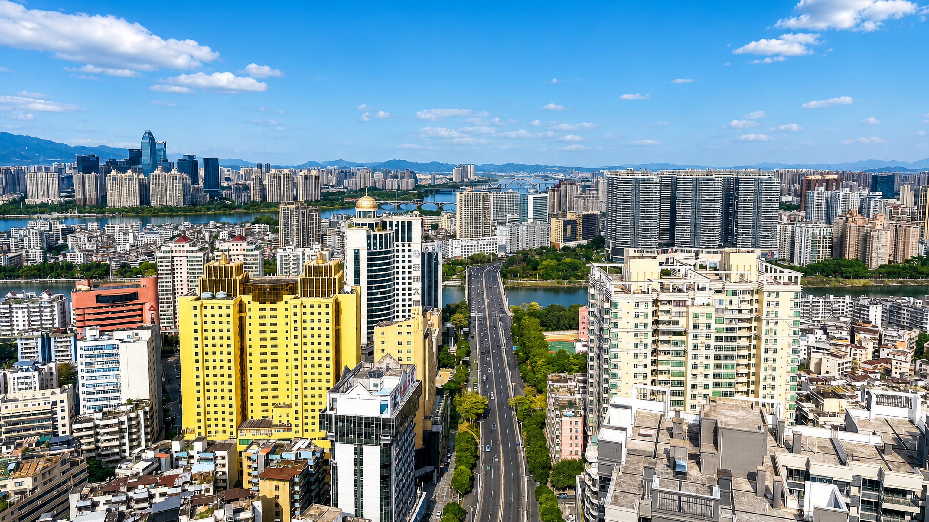Huizhou's high-rise avenue running down to the river and distant hills in Guangdong, China.