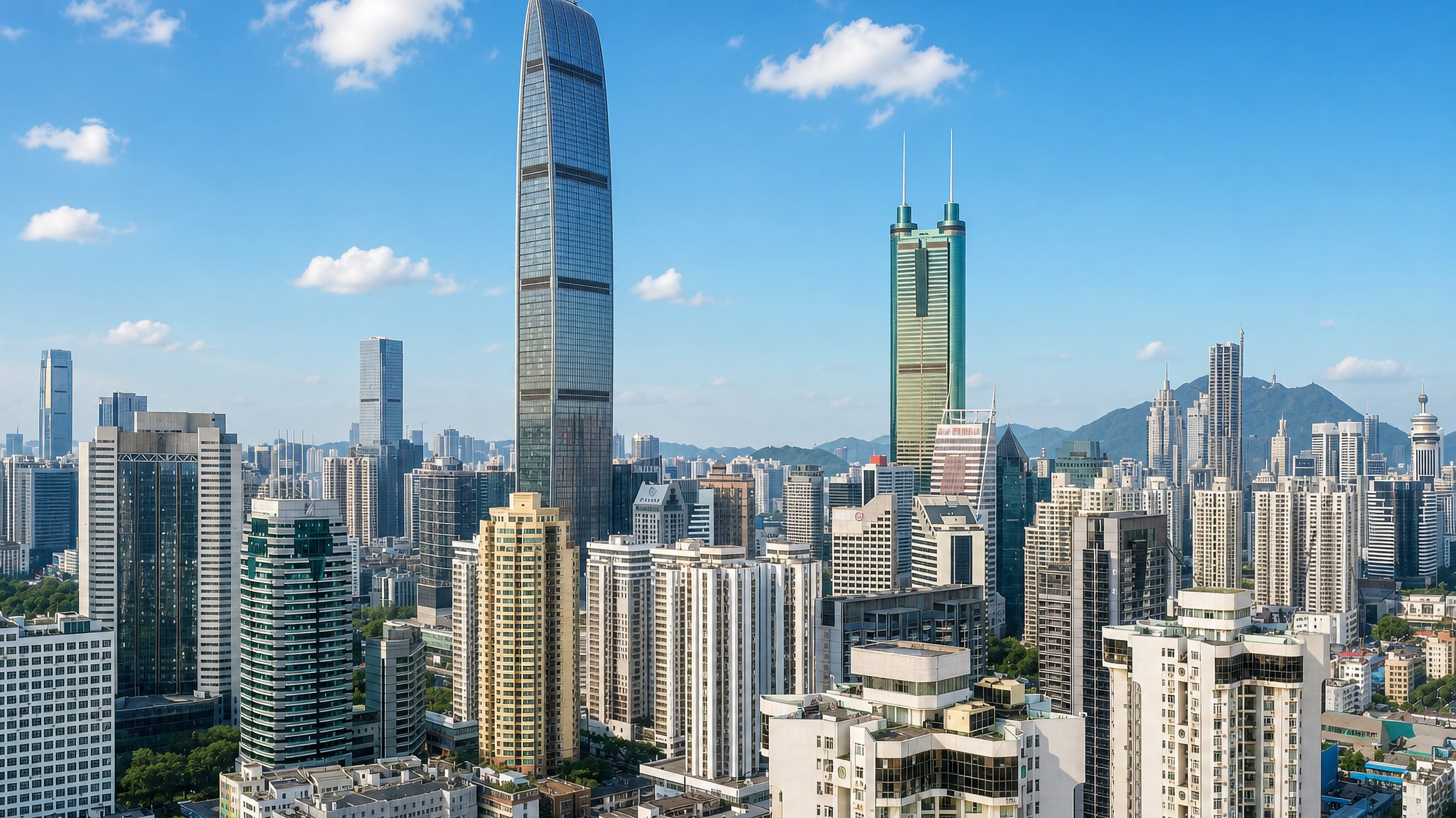 Luohu District skyline in Shenzhen, with a tapered supertall and a green-topped twin-mast tower above dense blocks.