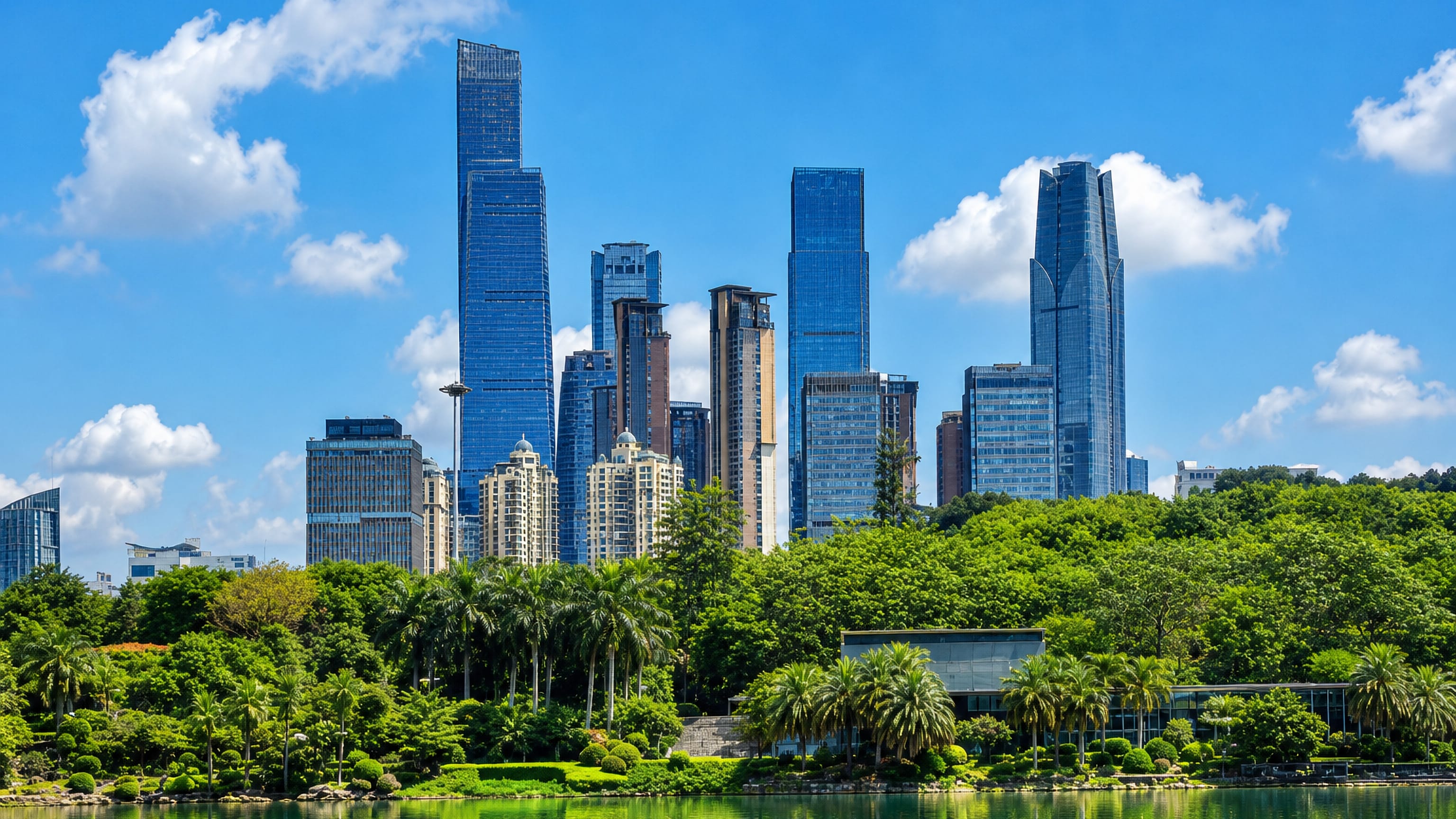 Nanning's glass high-rise skyline rising above palm-lined parkland and a calm lake in Guangxi, China.