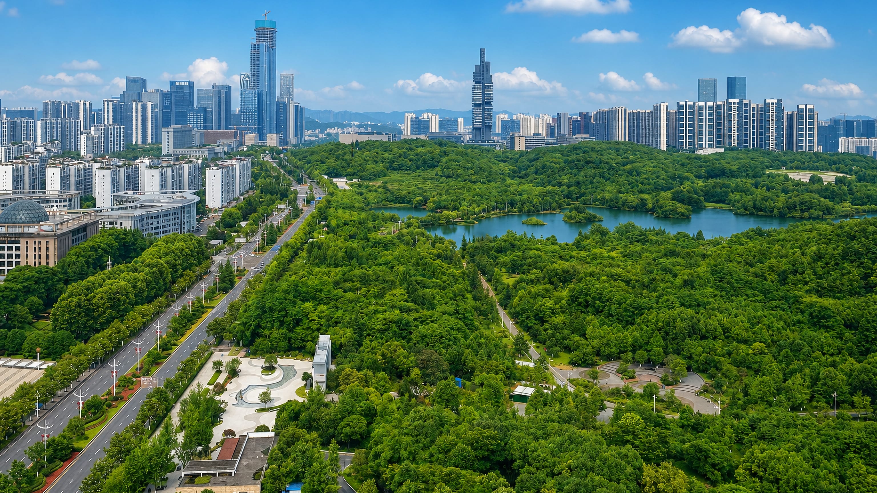 Guiyang, Guizhou, with high-rise towers rising beyond a large forested city park and its lake.