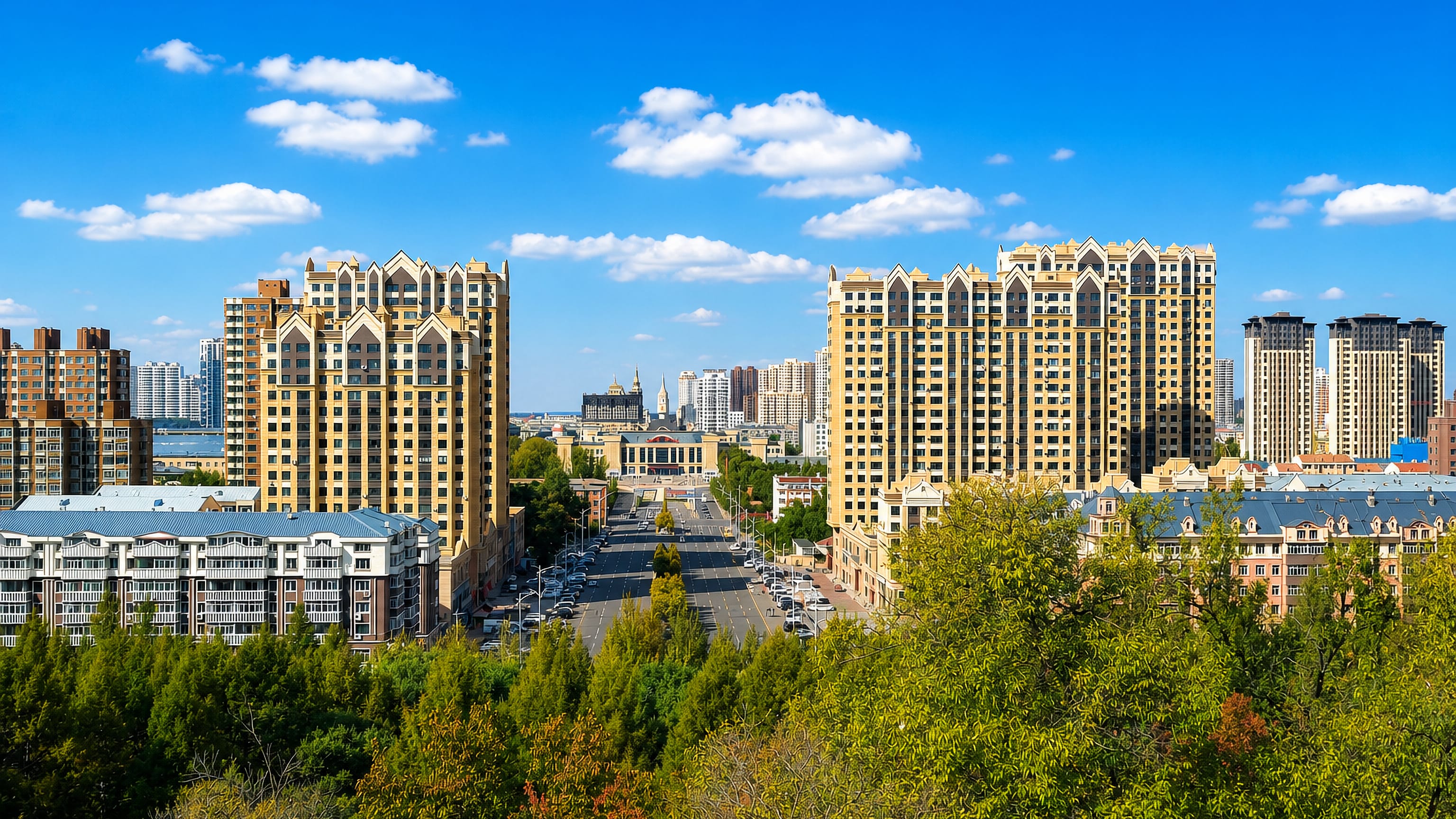 A tree-lined boulevard runs between beige high-rise apartment towers toward a domed civic hall in Jiamusi, China.