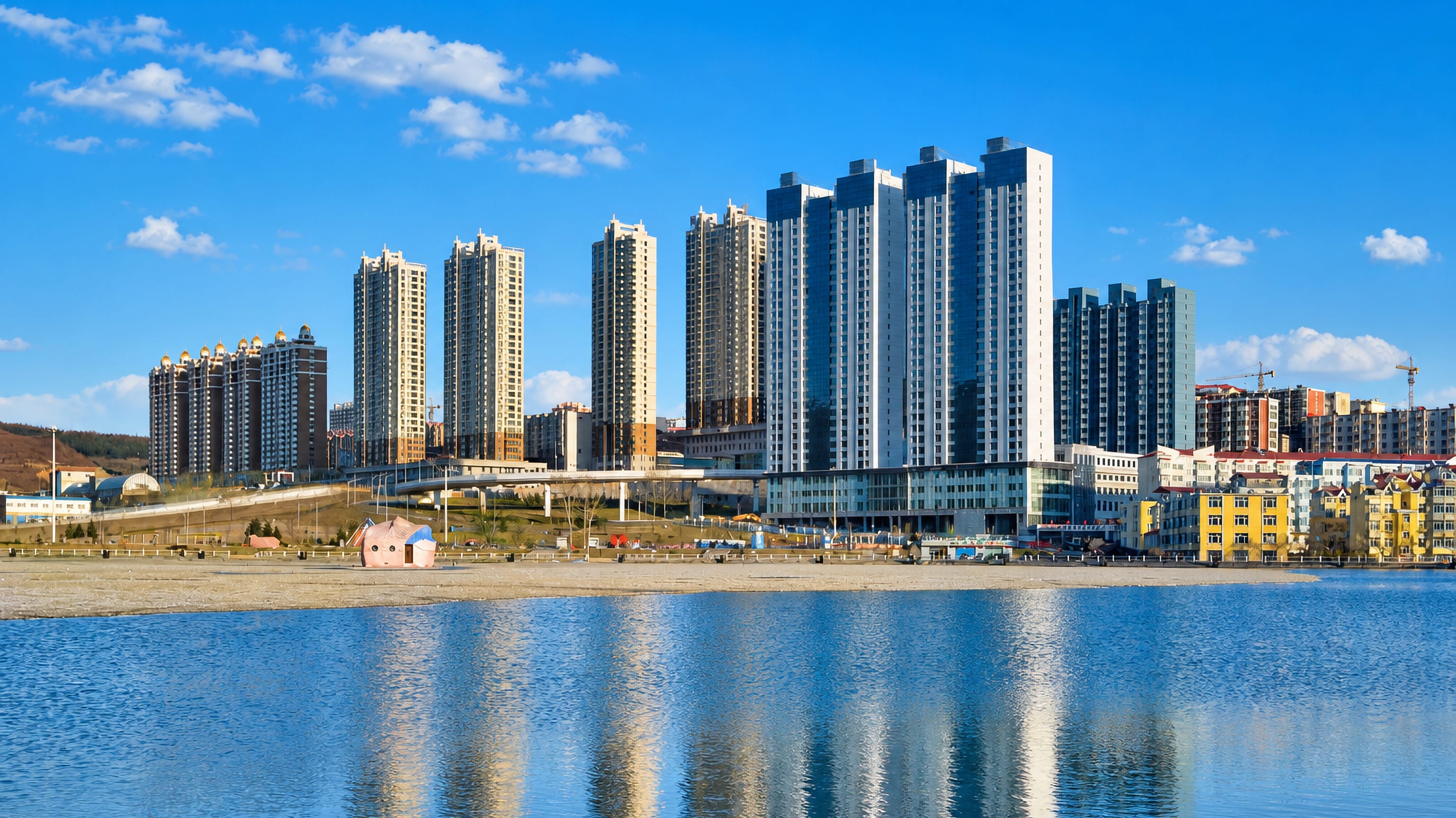 High-rise apartment blocks reflected in the water at Suifenhe, a border city in Heilongjiang, China