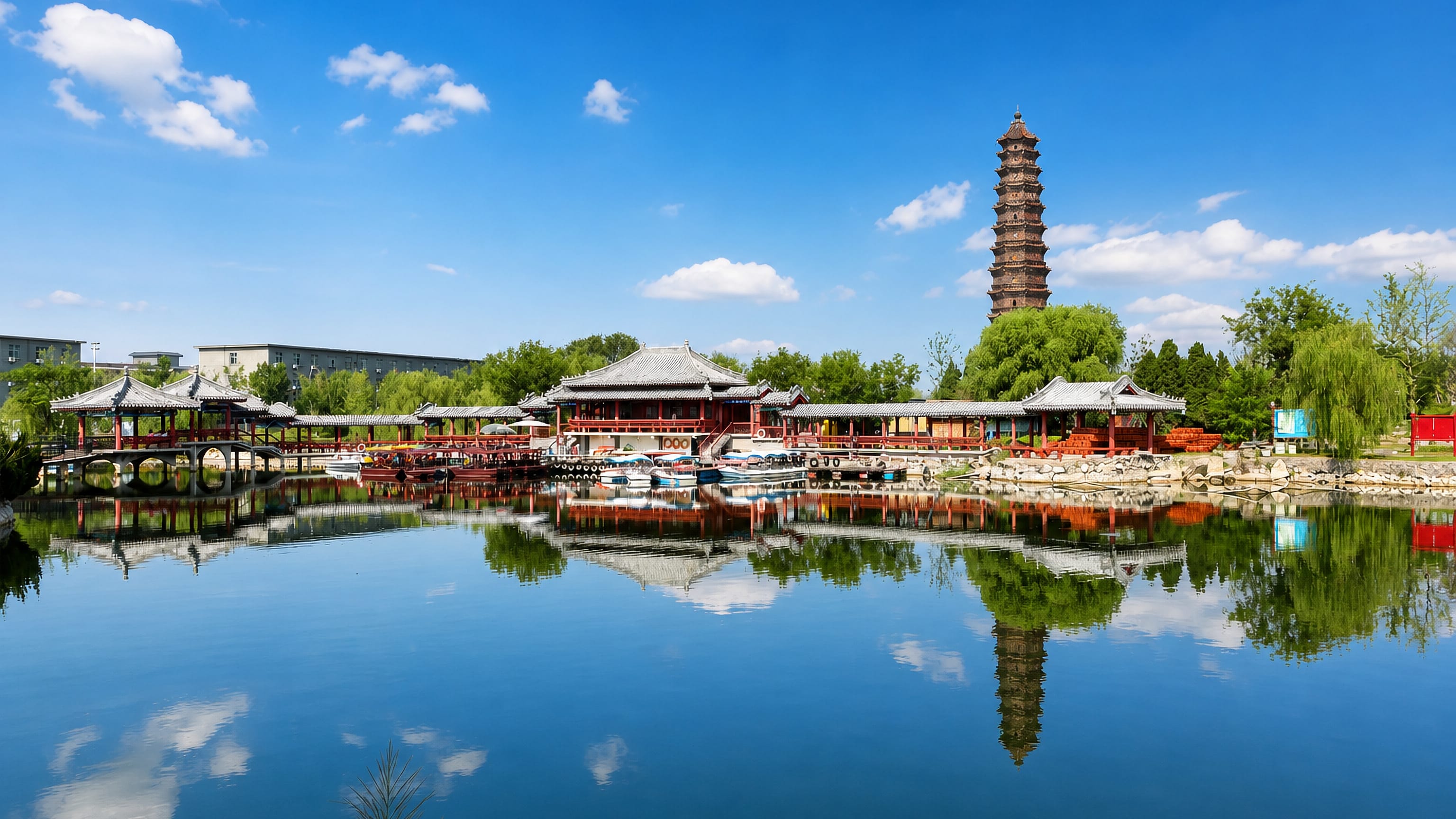Kaifeng's tiered Iron Pagoda rising above lakeside pavilions and pleasure boats in Iron Pagoda Park