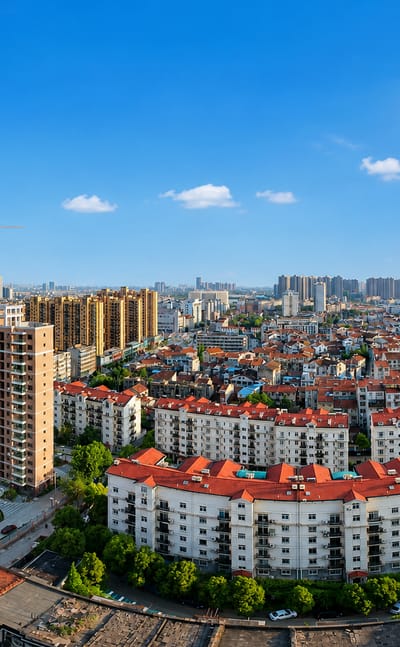 Dense residential apartment blocks and high-rises under blue sky in Wuhan