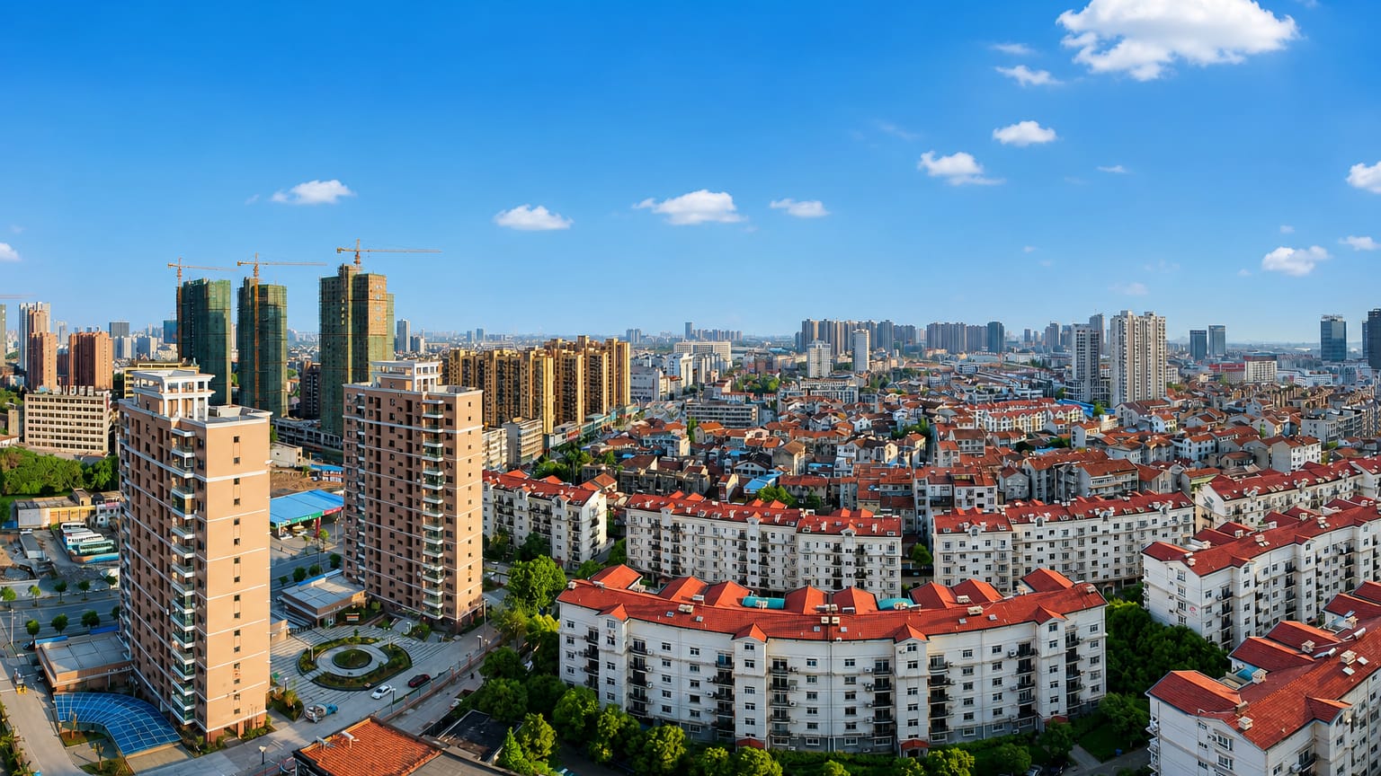 Dense residential apartment blocks and high-rises under blue sky in Wuhan