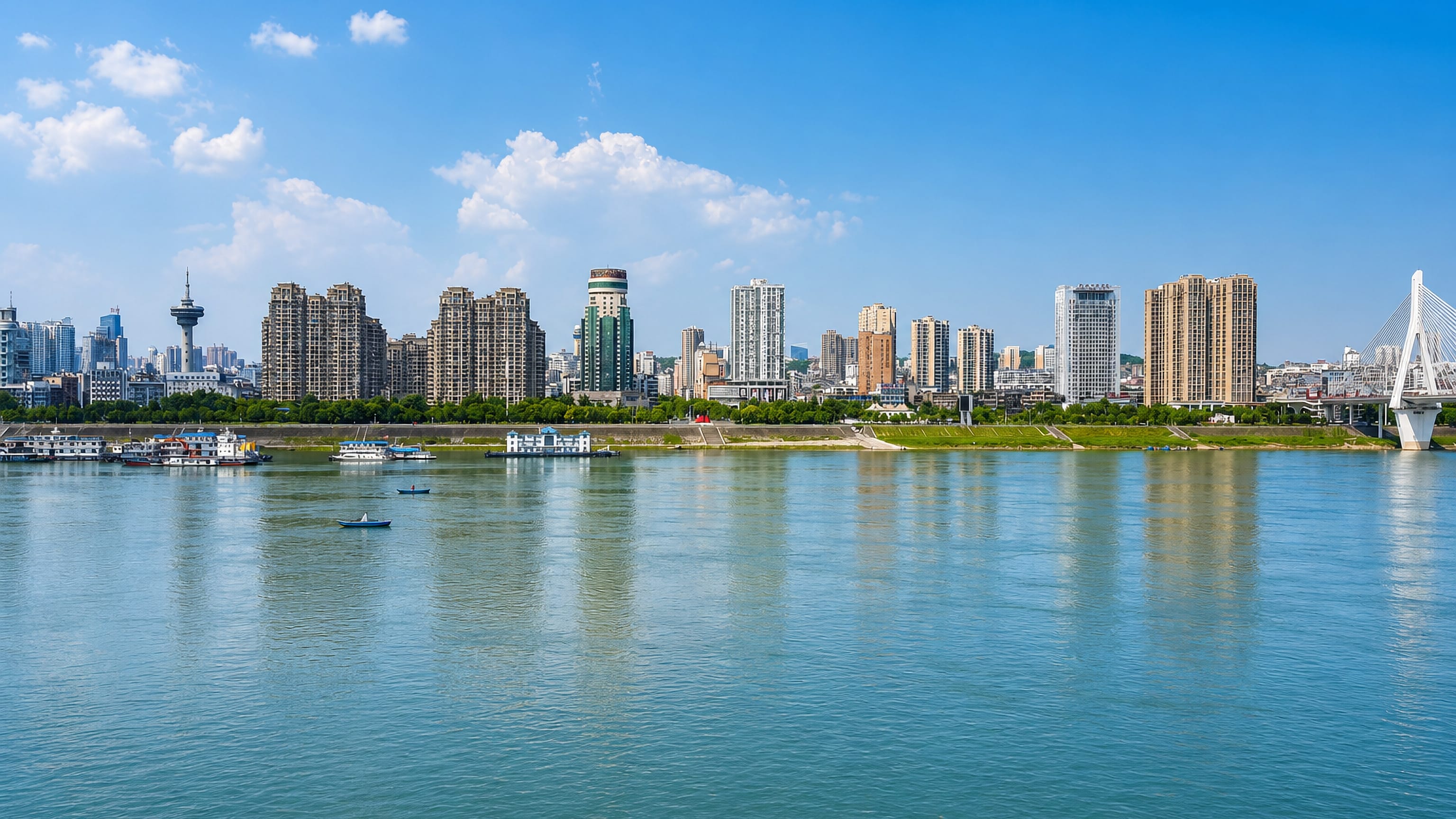Yichang's riverfront towers along the Yangtze, with a cable-stayed bridge closing the skyline.