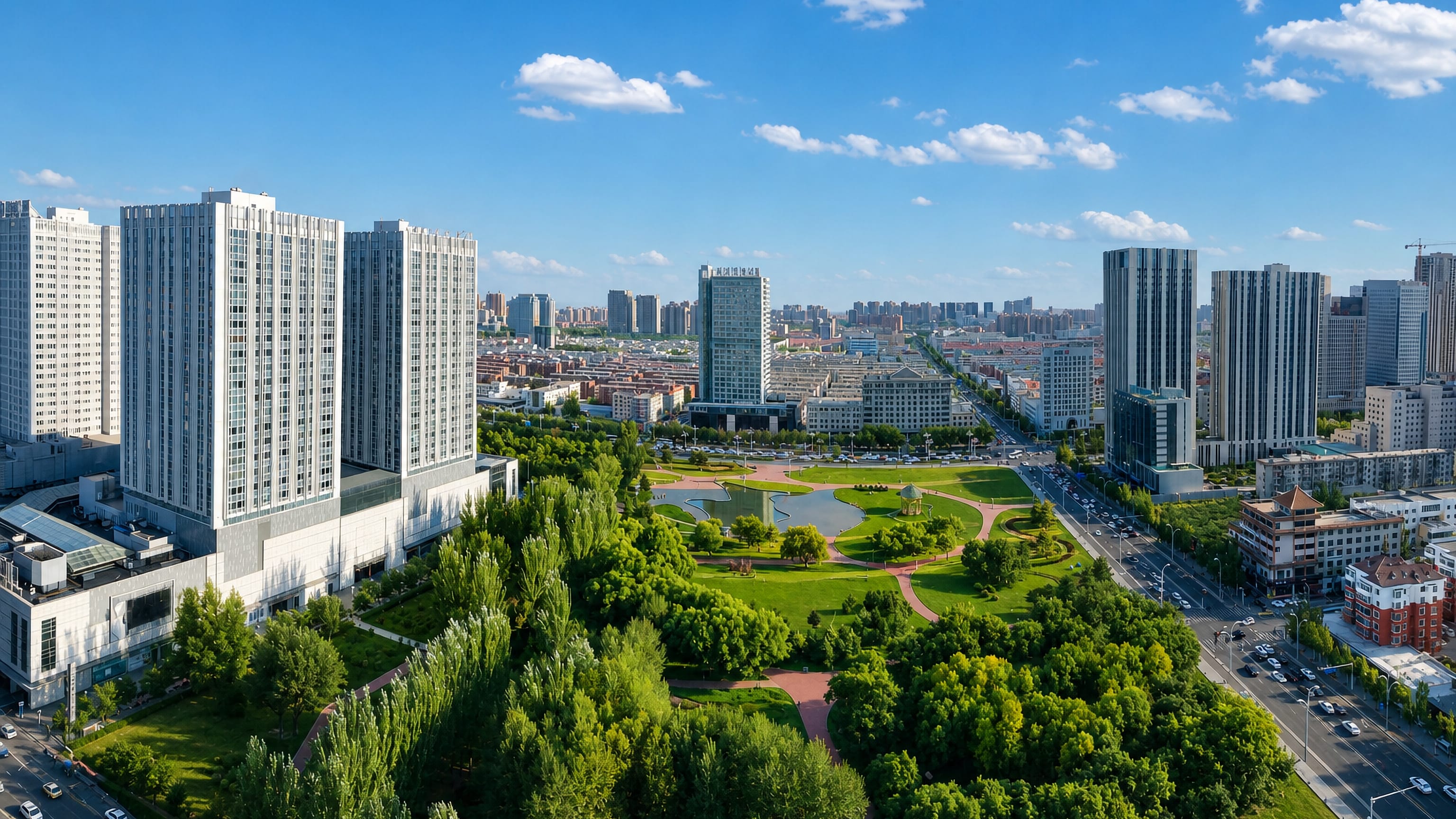 Aerial view of Hondlon district, Baotou, with high-rise blocks and wide boulevards around a central park.