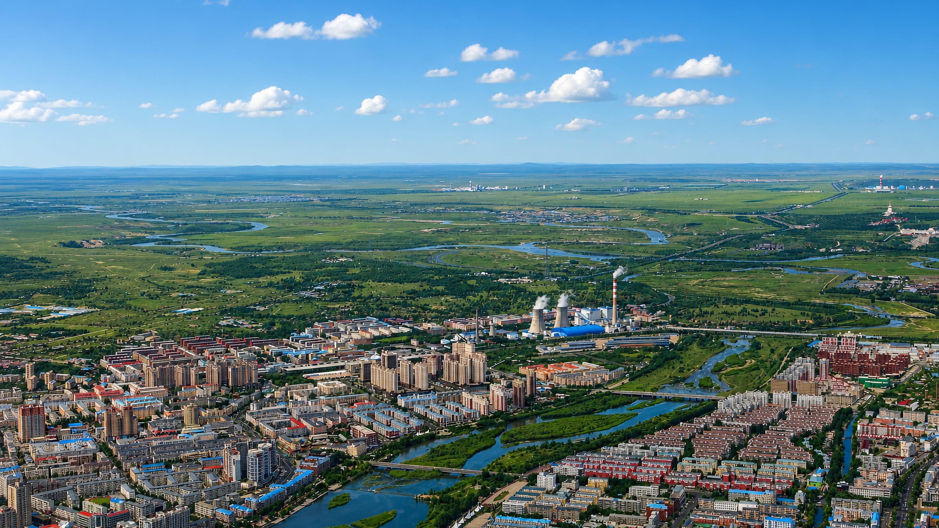 Aerial view of Hailar, Inner Mongolia, its riverside blocks ringed by Hulunbuir grassland.