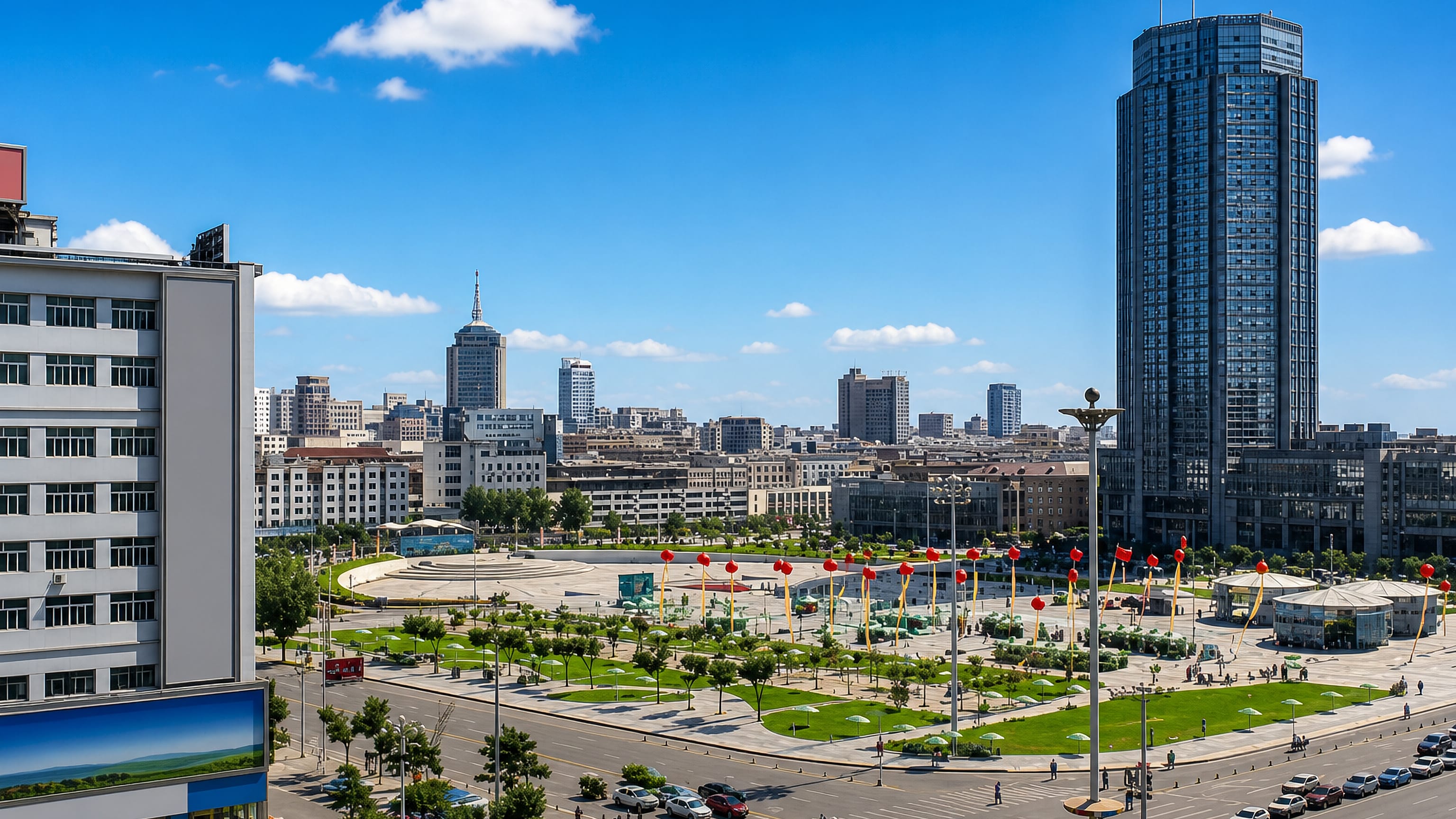 Wide civic plaza in Hohhot lined with red lantern banners, backed by a glass tower and the city skyline.