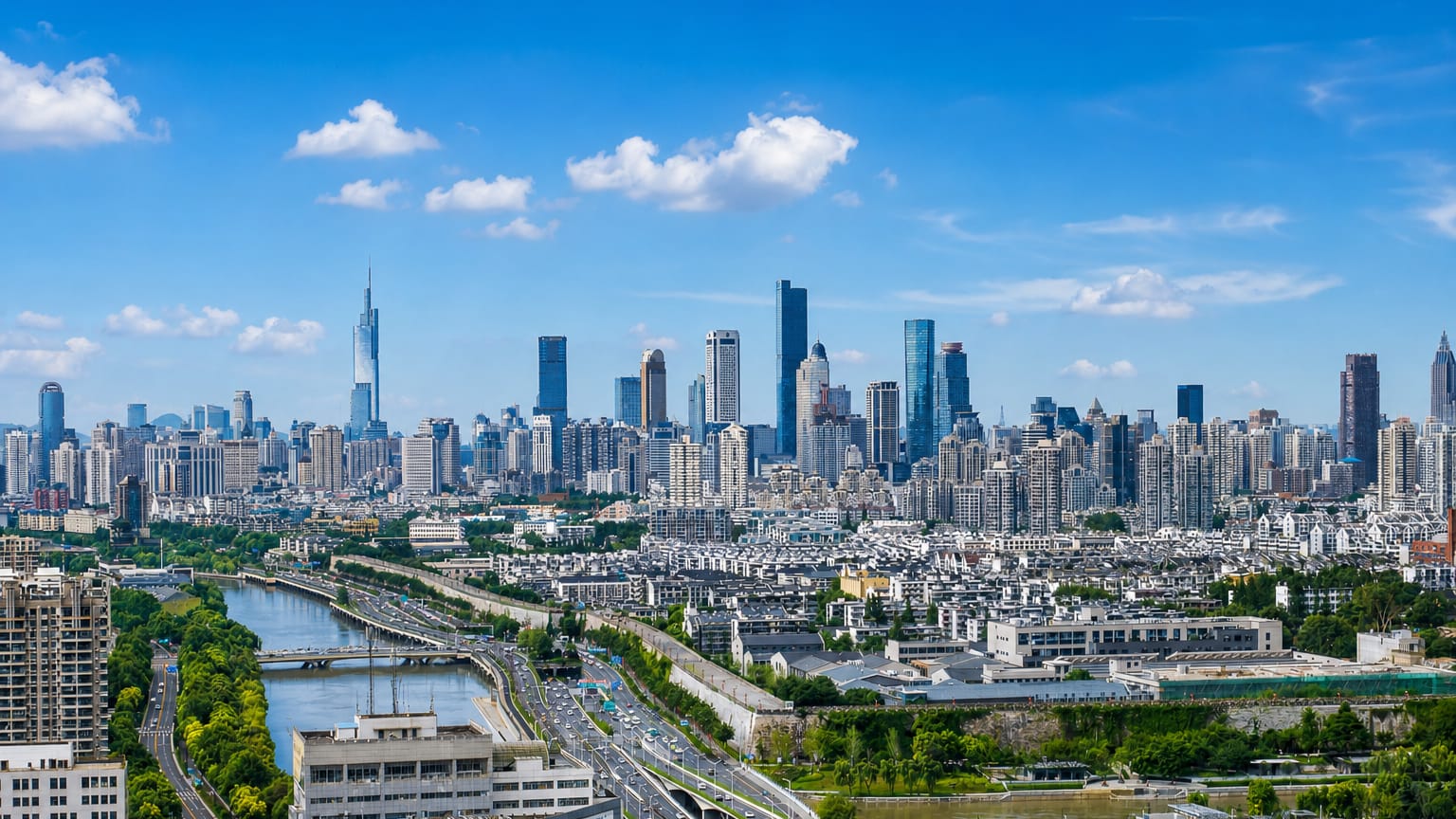 Nanjing skyline with the spired Zifeng Tower and a high-rise cluster above a canal and elevated highway