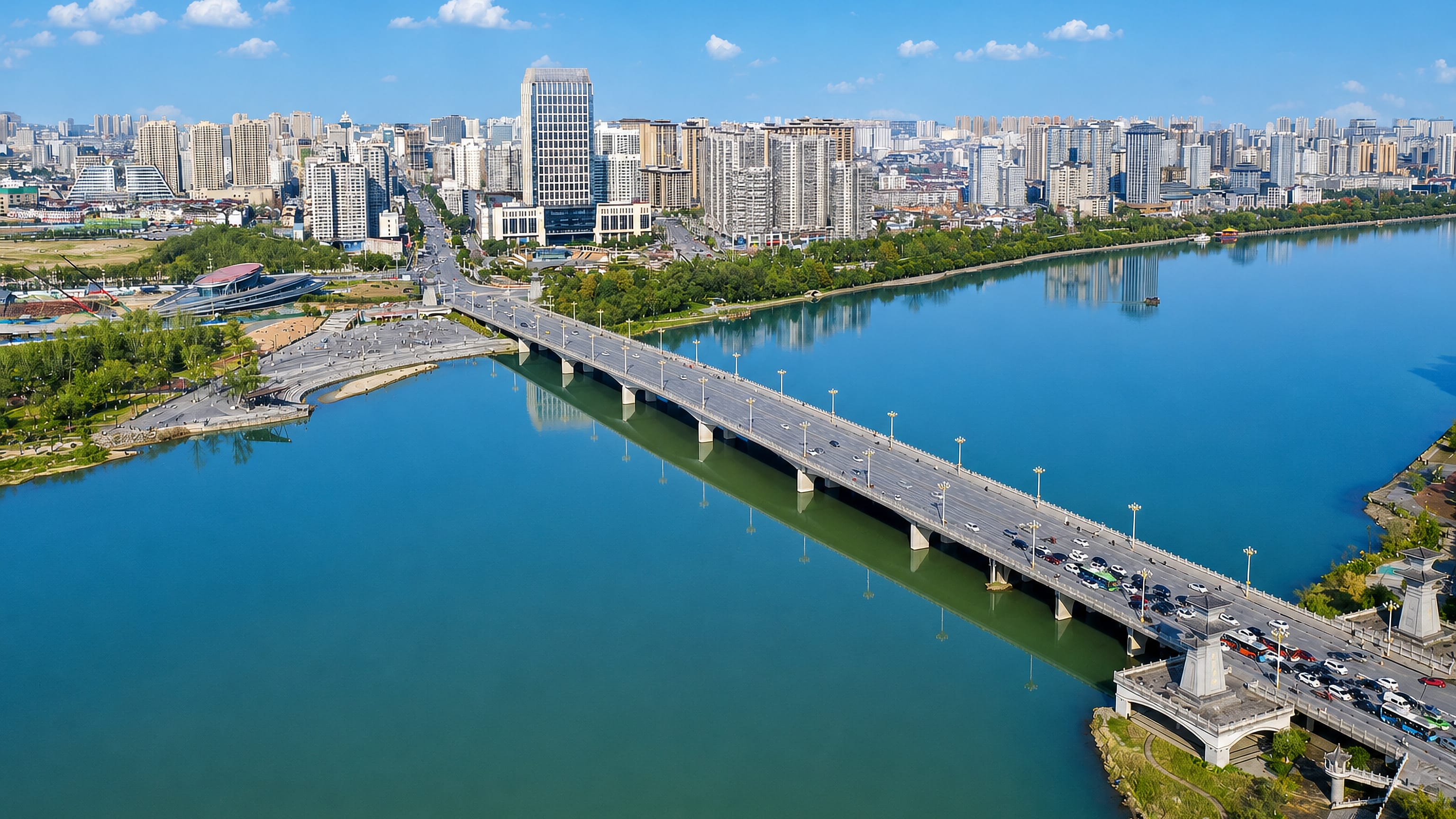 Aerial view of Hanzhong, China, with a road bridge crossing the Han River toward the city's skyline.