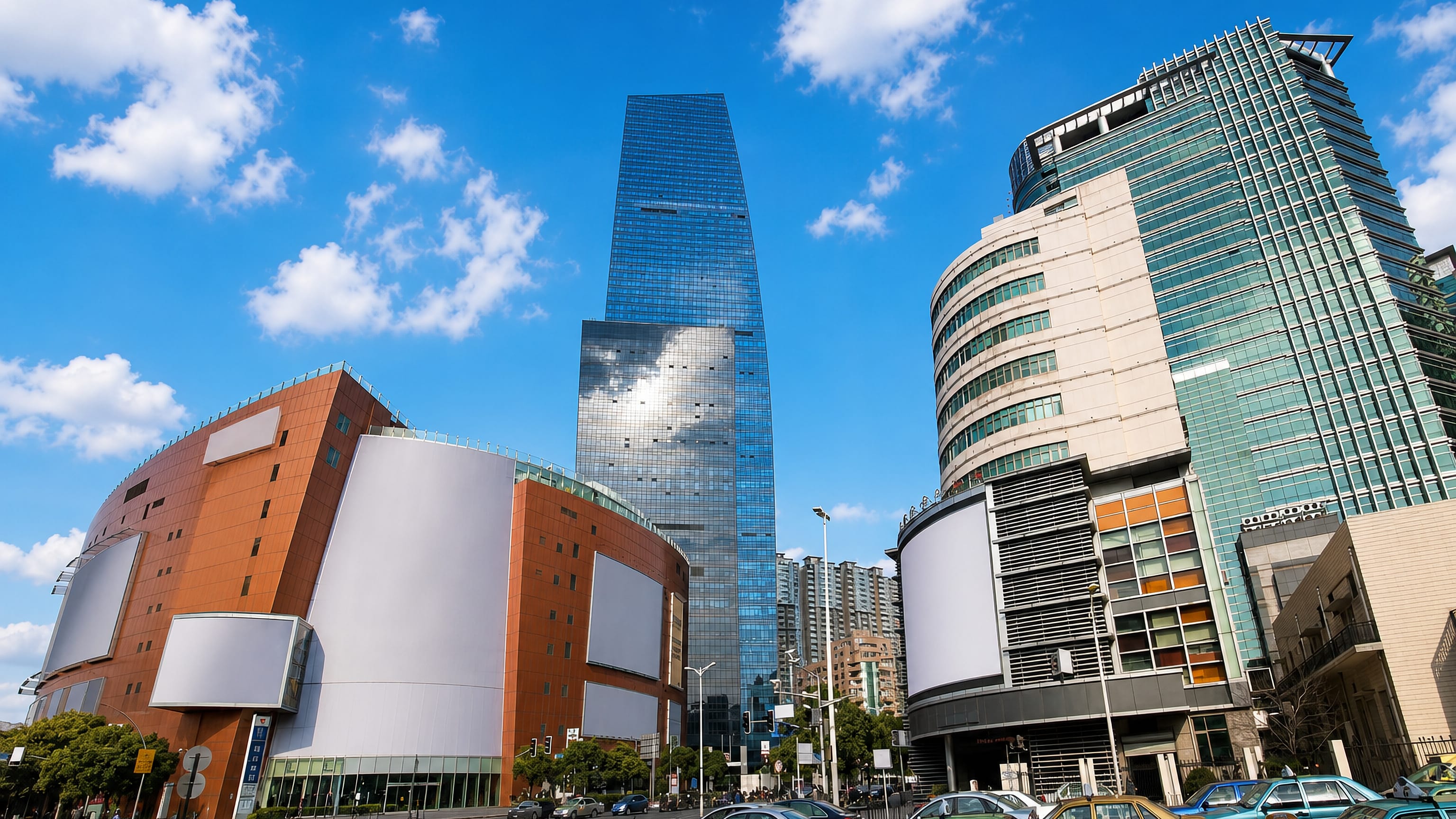 Shopping-mall facades and a glass office tower above busy traffic in Changning District, Shanghai.