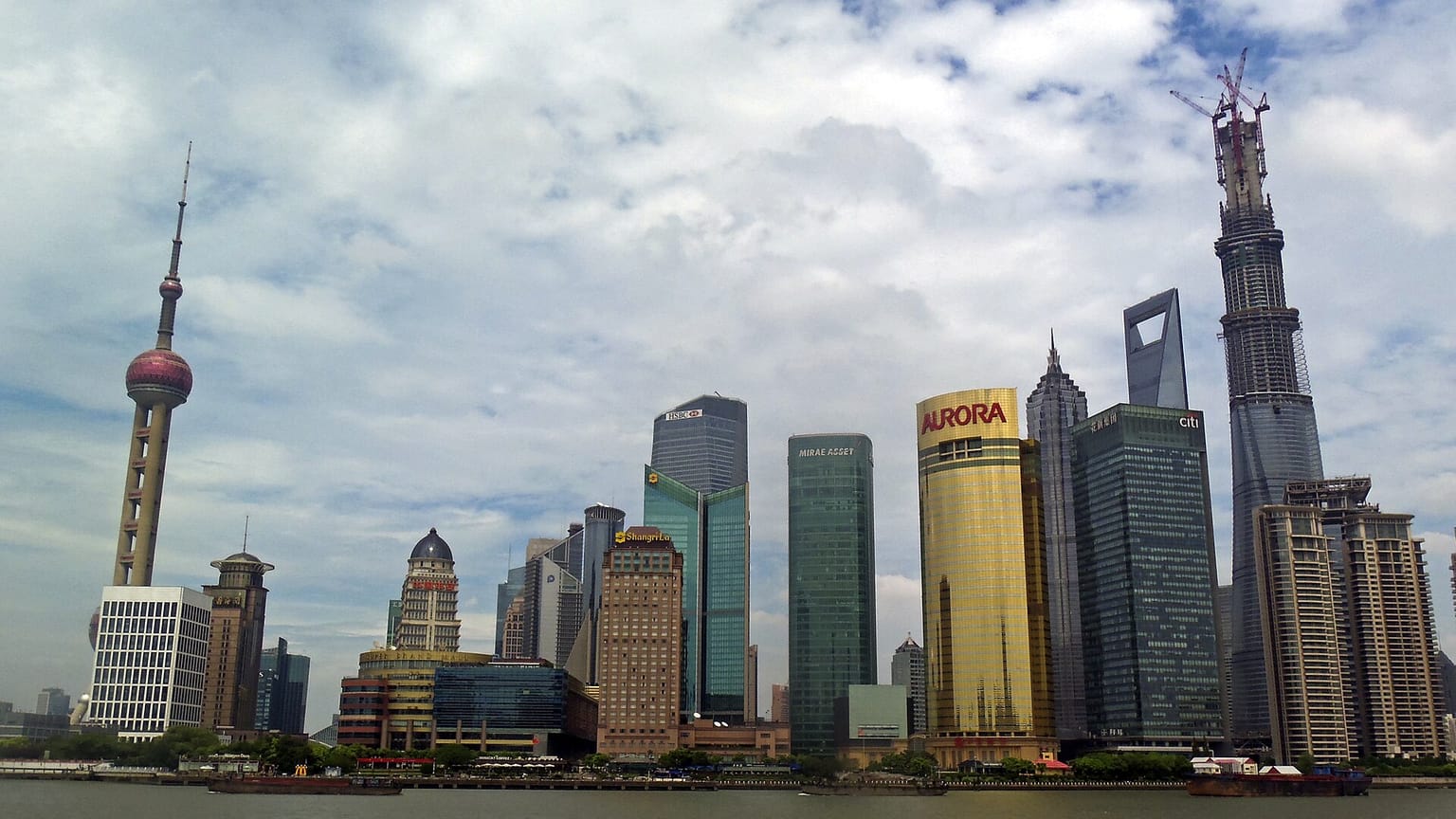 The Lujiazui skyline seen from the Huangpu waterfront in Shanghai, with the Oriental Pearl Tower and riverside towers