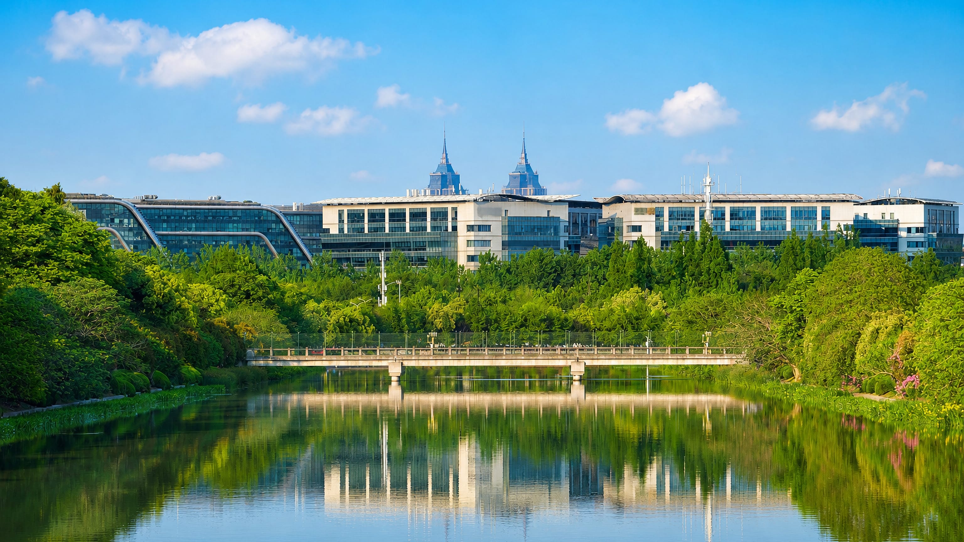 Modern campus buildings and spired towers reflected in a canal in Jiading, Shanghai.