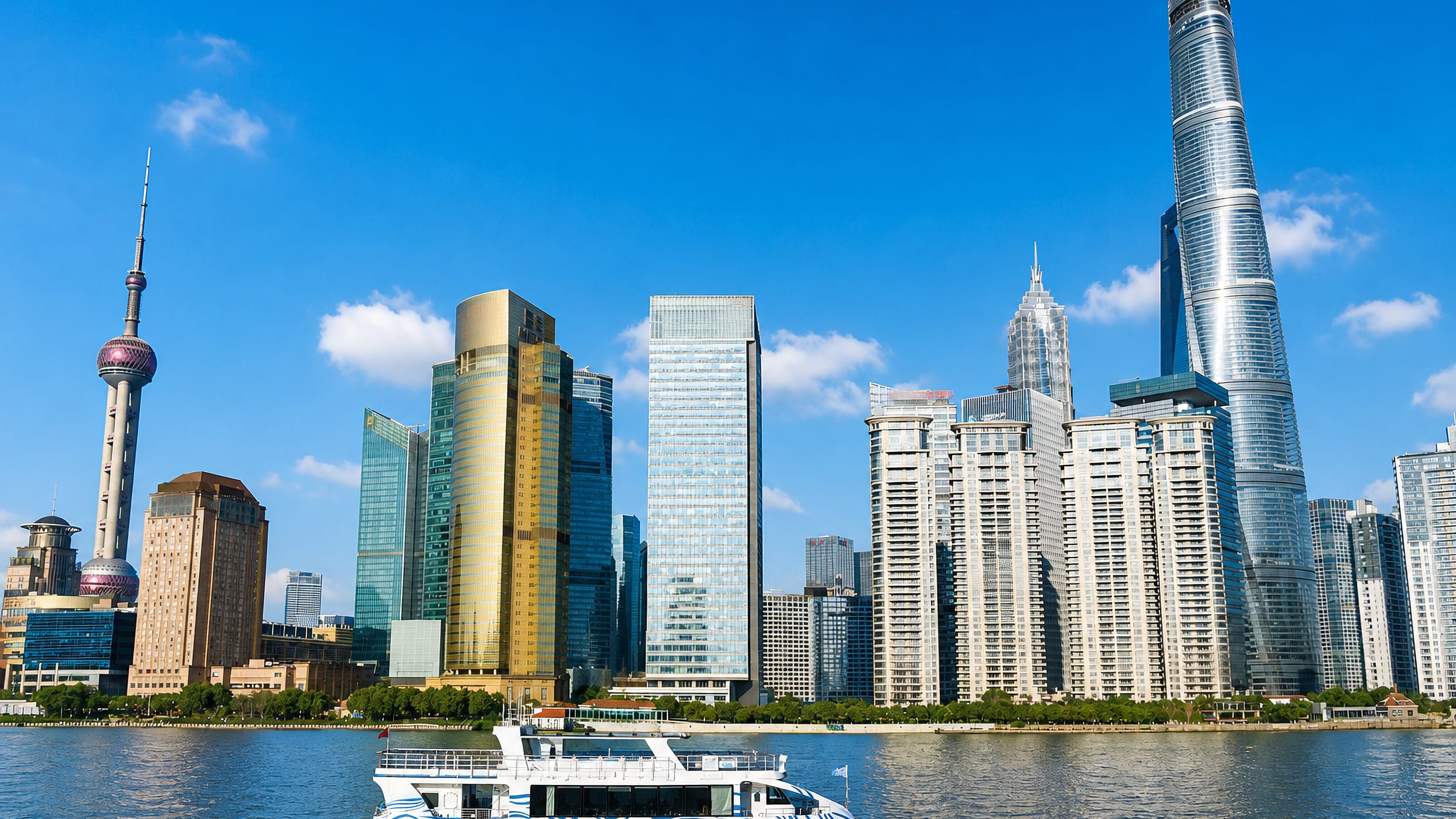 Pudong's Huangpu River skyline in Shanghai with the Oriental Pearl Tower, Jin Mao Tower and Shanghai Tower.