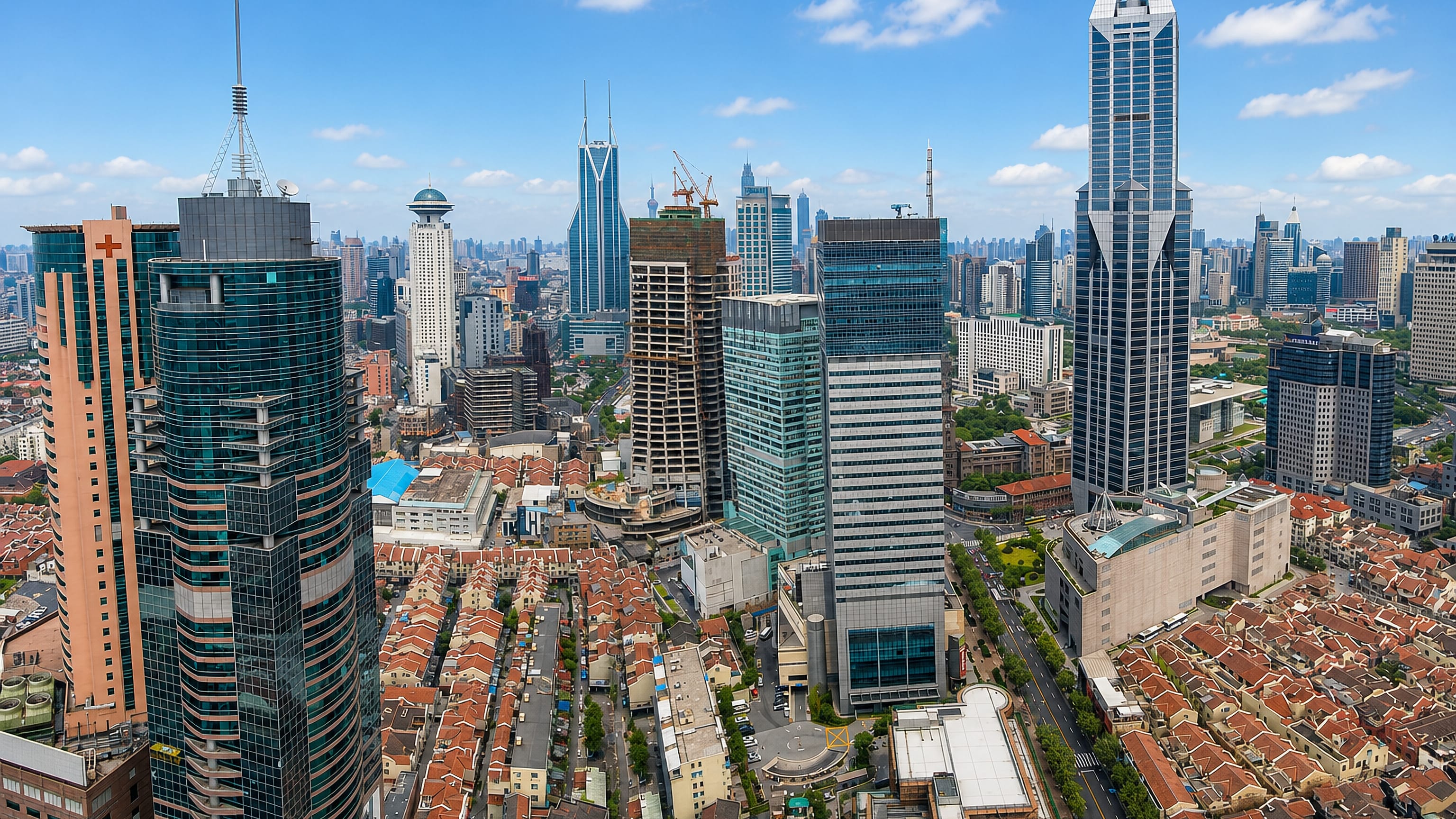 Puxi, Shanghai: high-rise towers around People's Square rising above the terracotta roofs of old lane housing