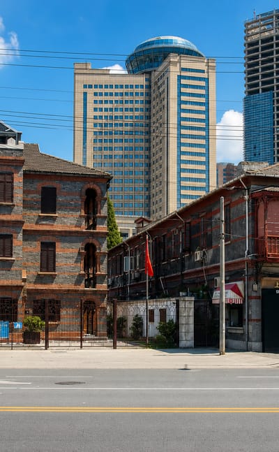 Shanghai Jewish Refugees Museum and historic Hongkou brick tenements of the former Shanghai Ghetto, with modern towers behind.