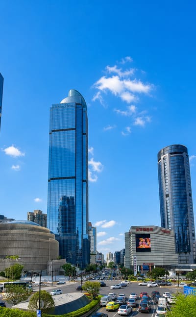 Glass skyscrapers of the Xujiahui commercial district in Shanghai's Xuhui District above a busy avenue.