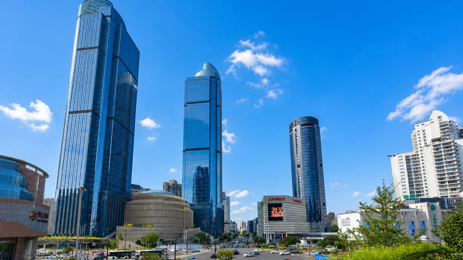 Glass skyscrapers of the Xujiahui commercial district in Shanghai's Xuhui District above a busy avenue.