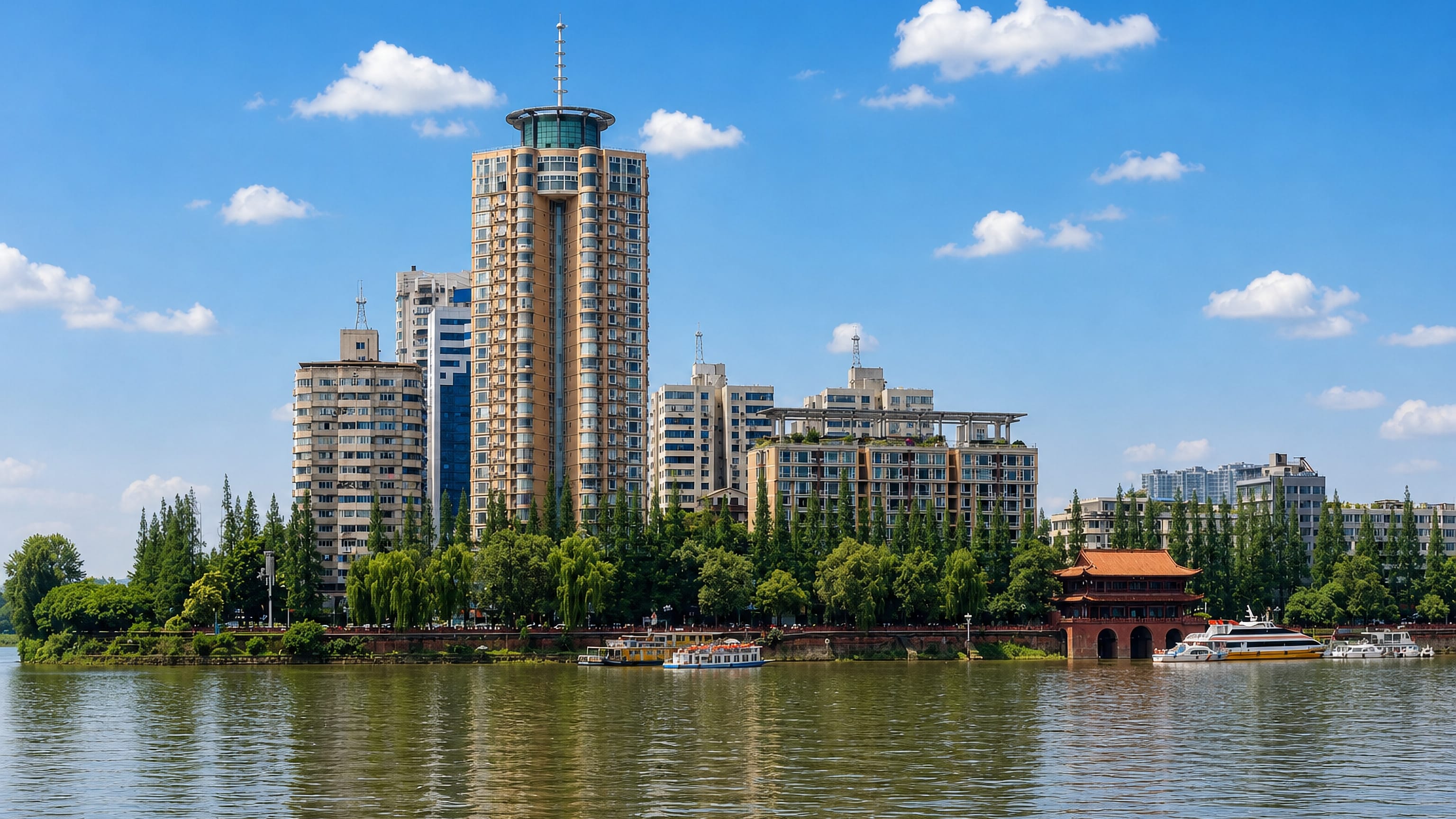 High-rise riverfront and a traditional pavilion along the Min River at Leshan, Sichuan, China.