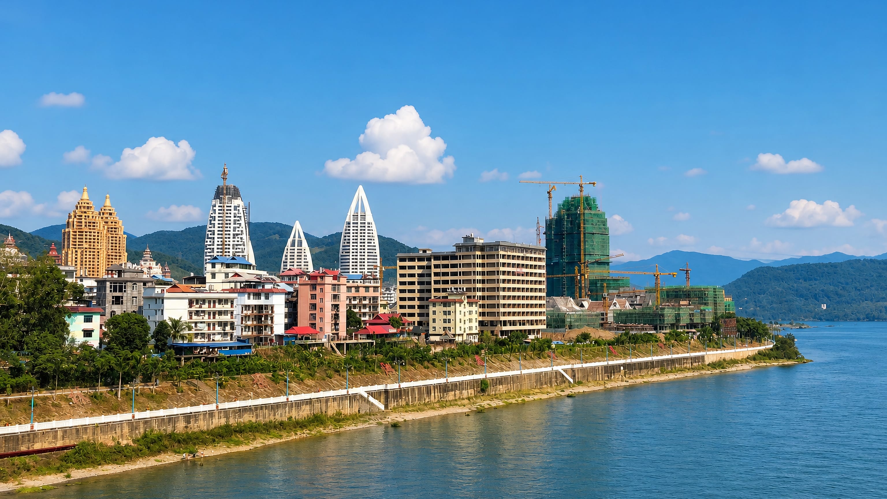 Jinghong's riverfront of Dai-style spired towers and apartment blocks above the Lancang (Mekong) River