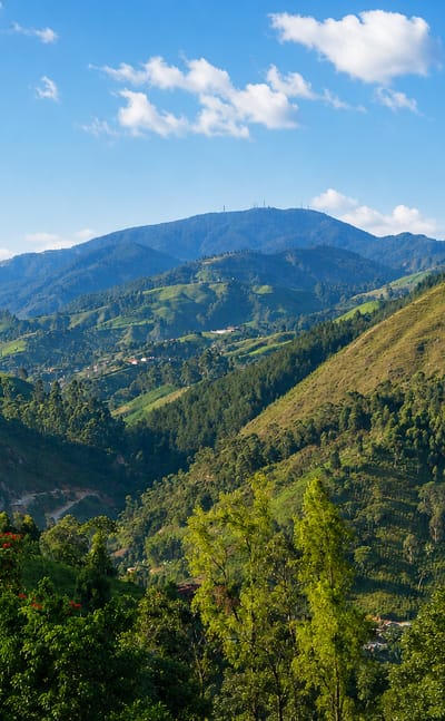 Green mountainous valley with forested hills near the San Antonio de Prado corregimiento of Medellin, Colombia.