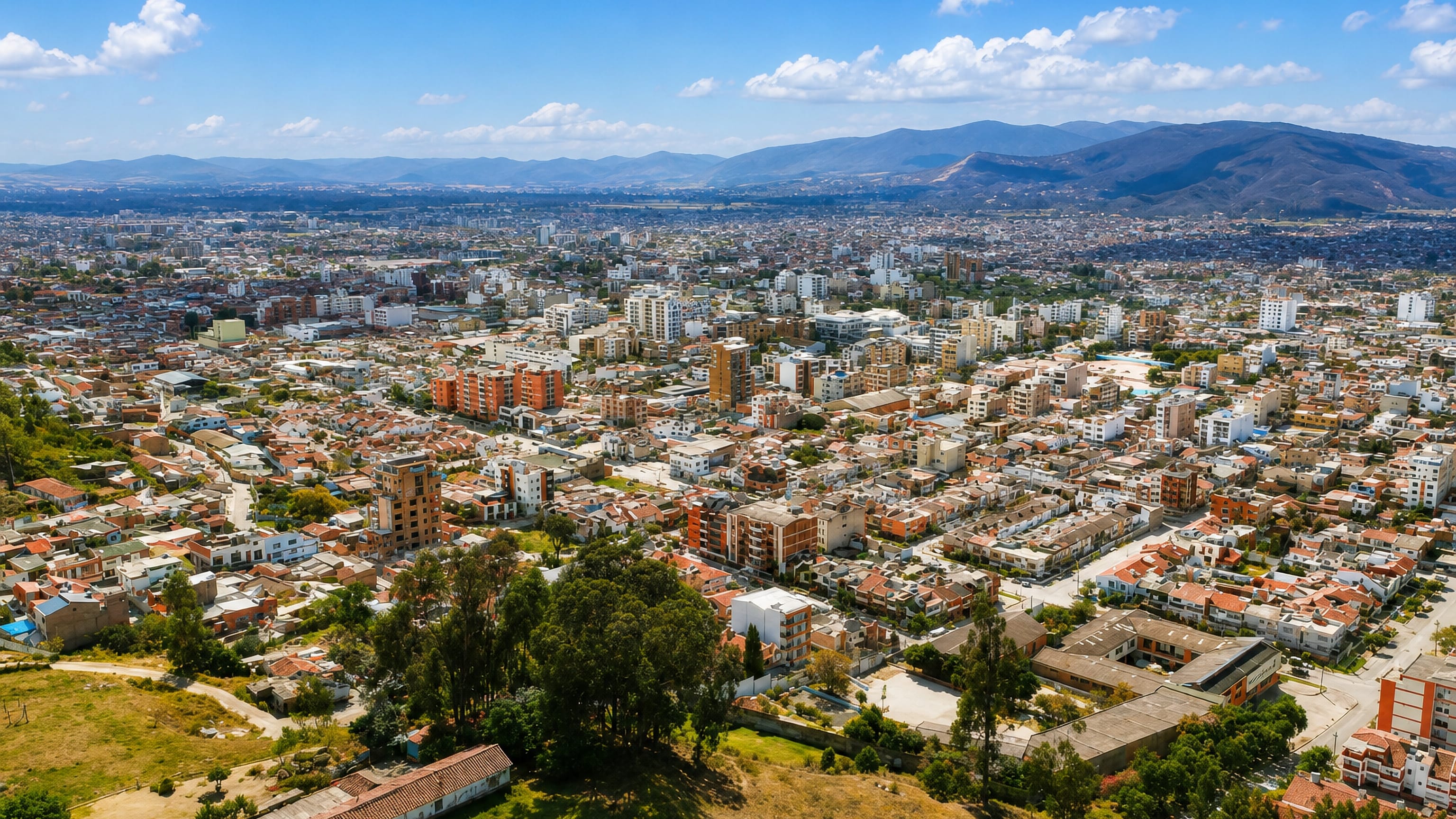 Sogamoso, Colombia, seen from a hillside: dense red-tiled rooftops filling the Boyacá valley under Andean ridges.