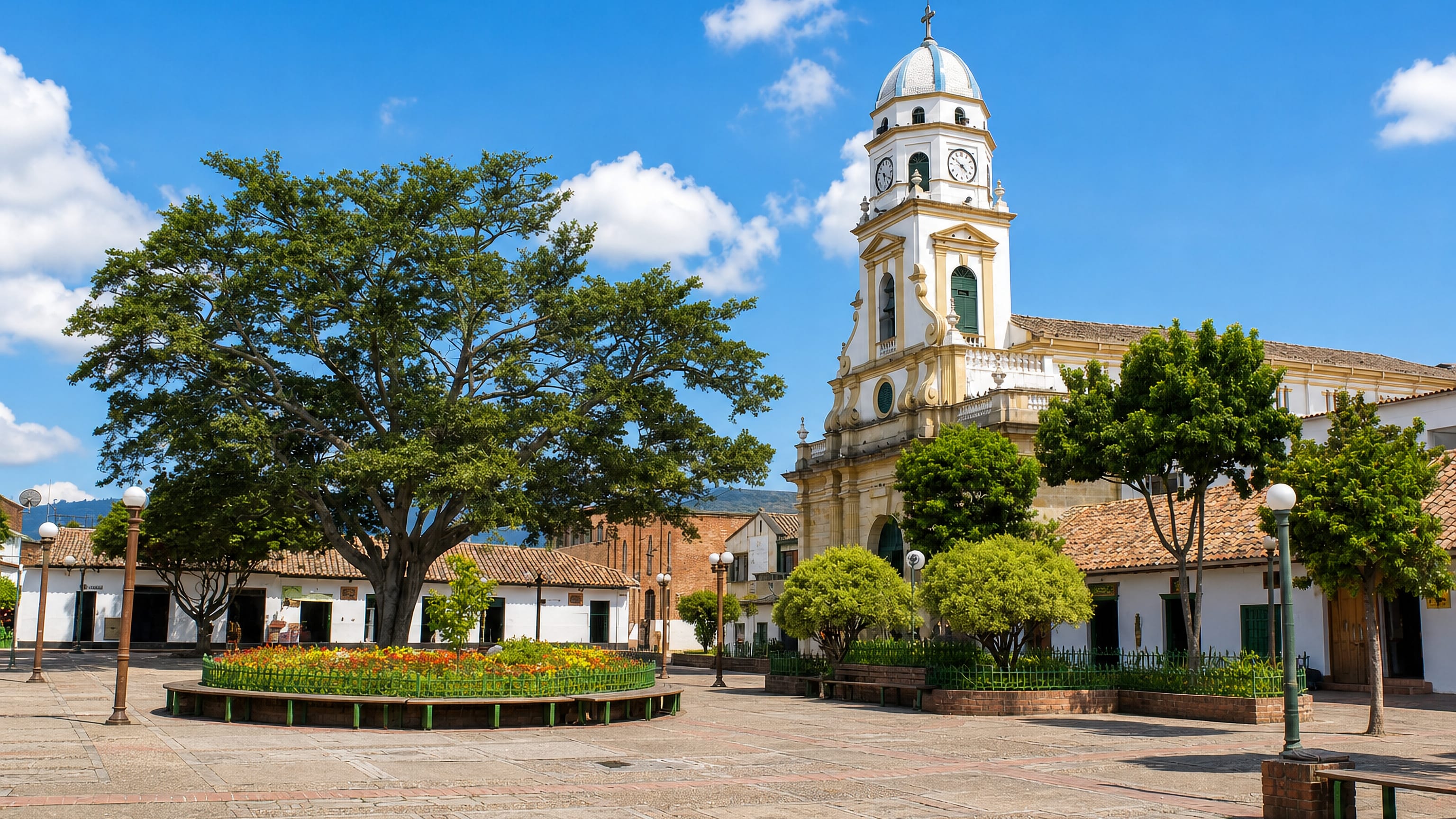 Colonial-style church with a domed clock tower on the tree-shaded main plaza of Chía, Cundinamarca, Colombia.