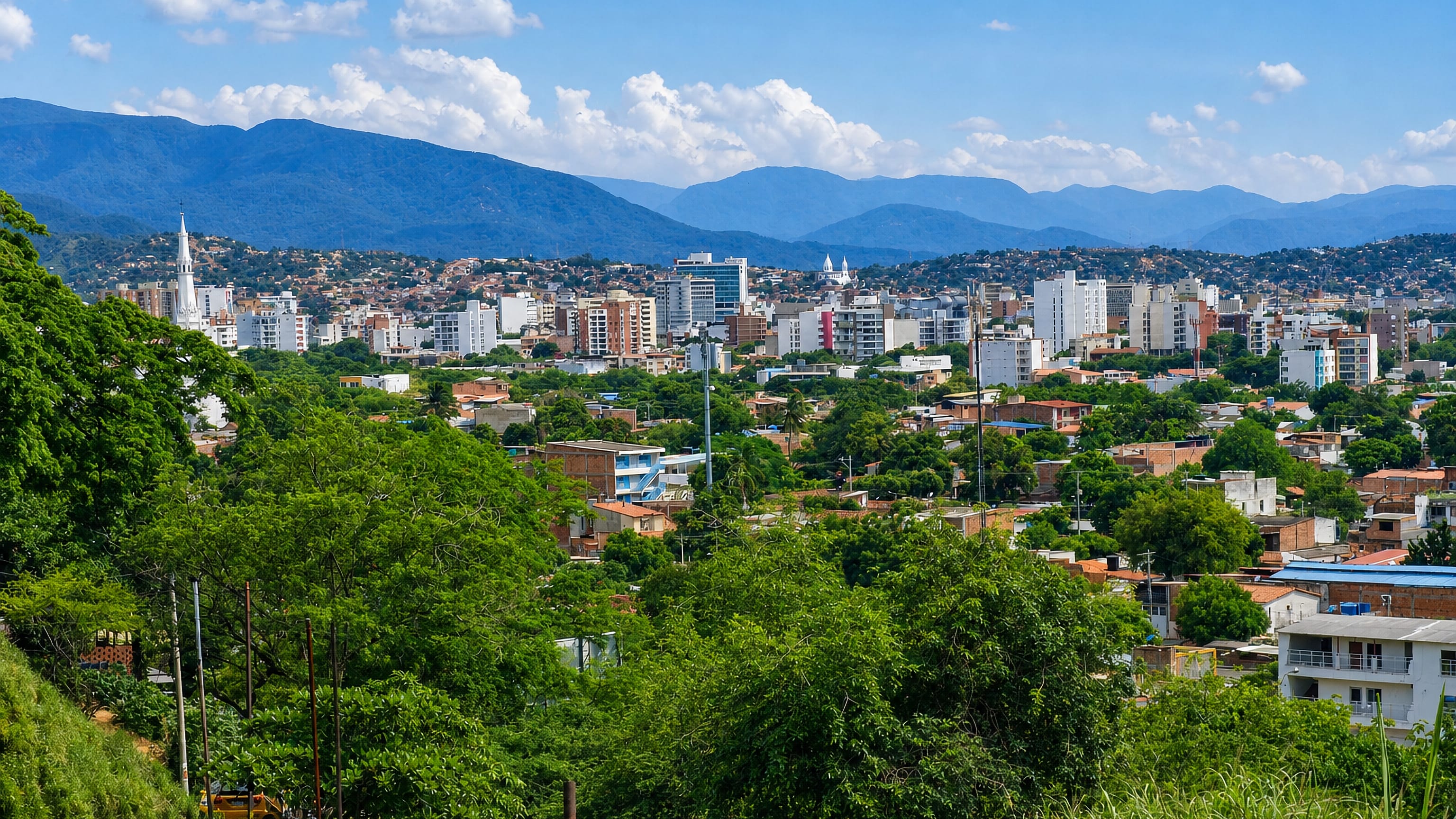 Cúcuta's white apartment blocks and church spire spread across a green valley below the Andean foothills