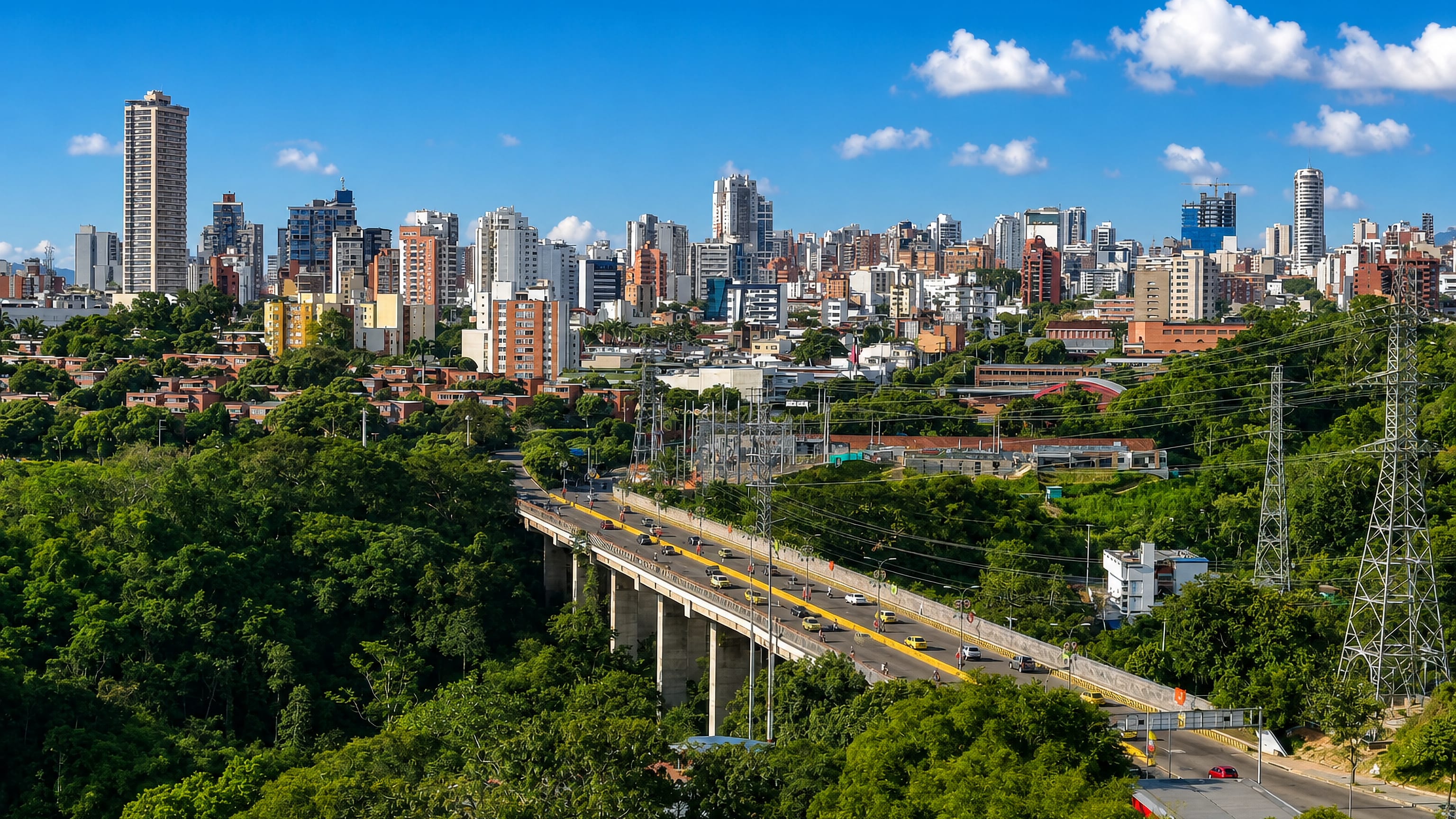 Bucaramanga's Cabecera high-rises rising above the wooded escarpment and the viaduct leading into the city.