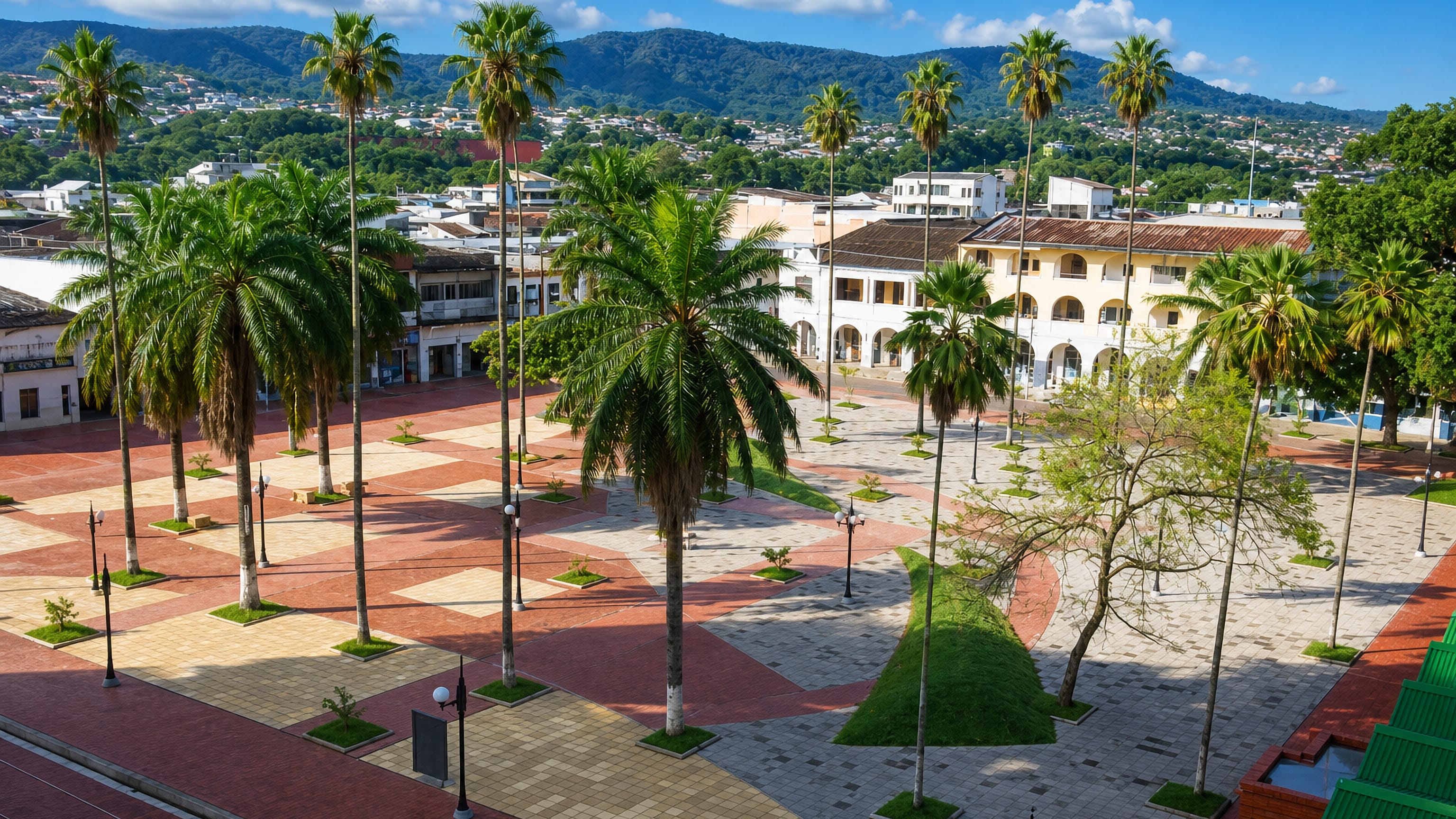 Palm-filled main plaza with arcaded buildings and green foothills in Florencia, Caquetá, Colombia
