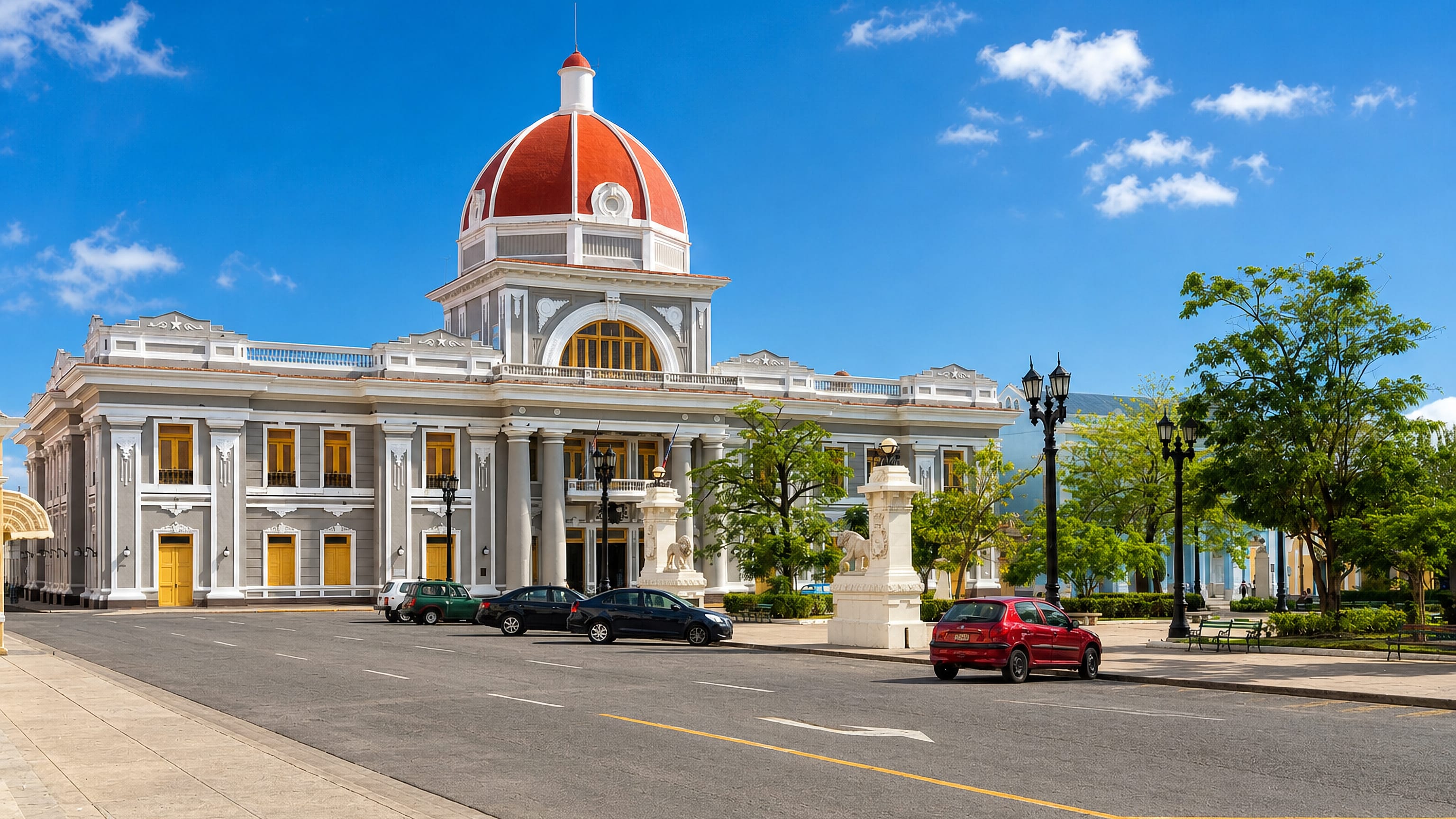 The red-domed Palacio de Gobierno fronts a broad plaza street in central Cienfuegos, Cuba.