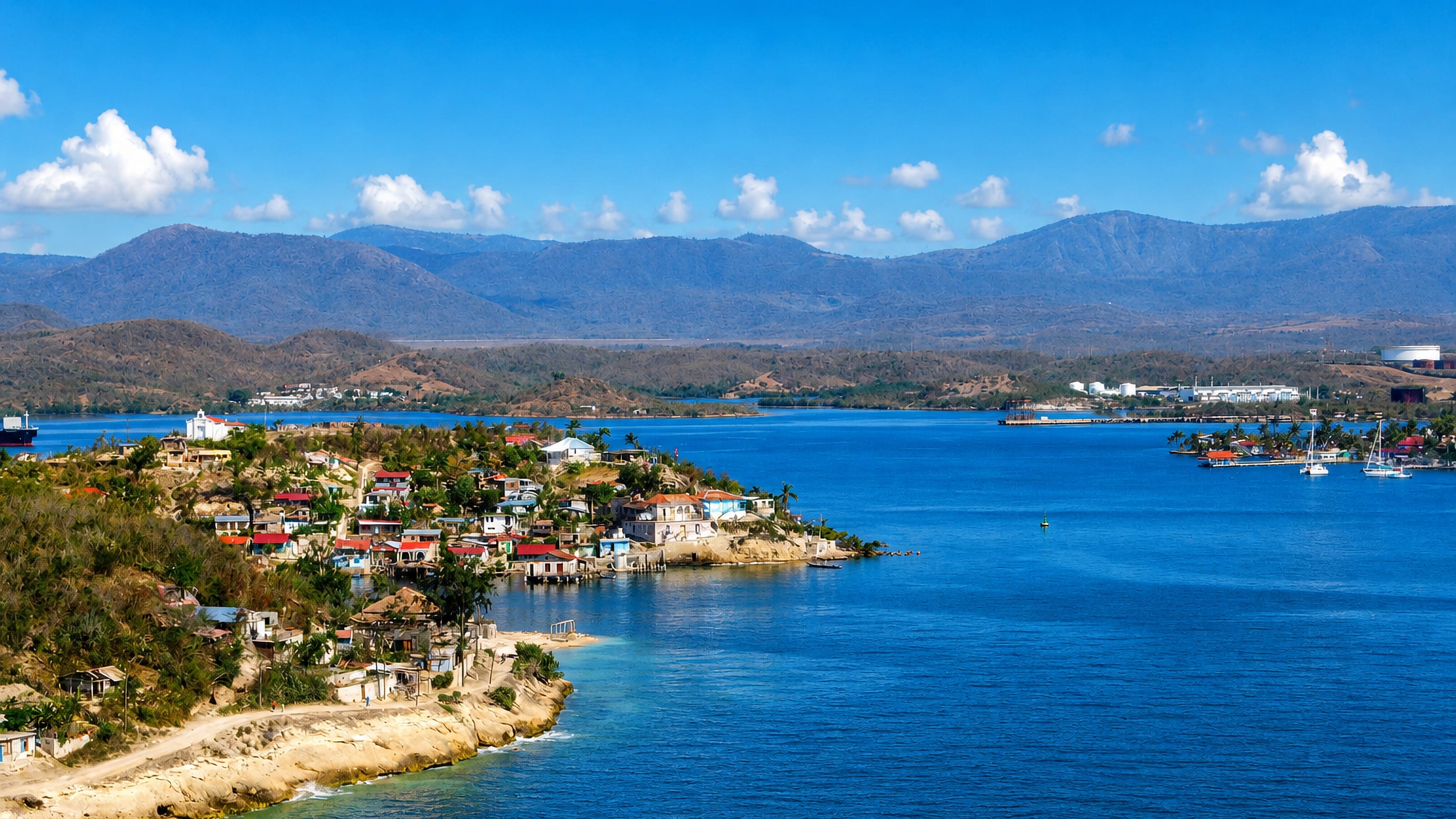 Colourful waterfront village on Santiago de Cuba's bay, backed by the Sierra Maestra mountains