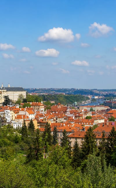 Prague Castle and St. Vitus Cathedral rising above the red rooftops of Mala Strana