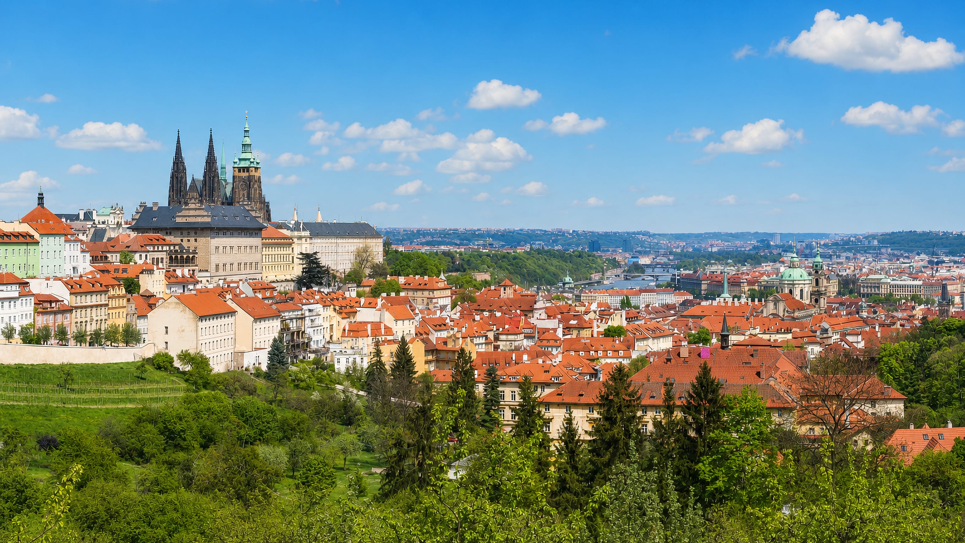 Prague Castle and St Vitus Cathedral rising above the red roofs of Hradčany, Prague.