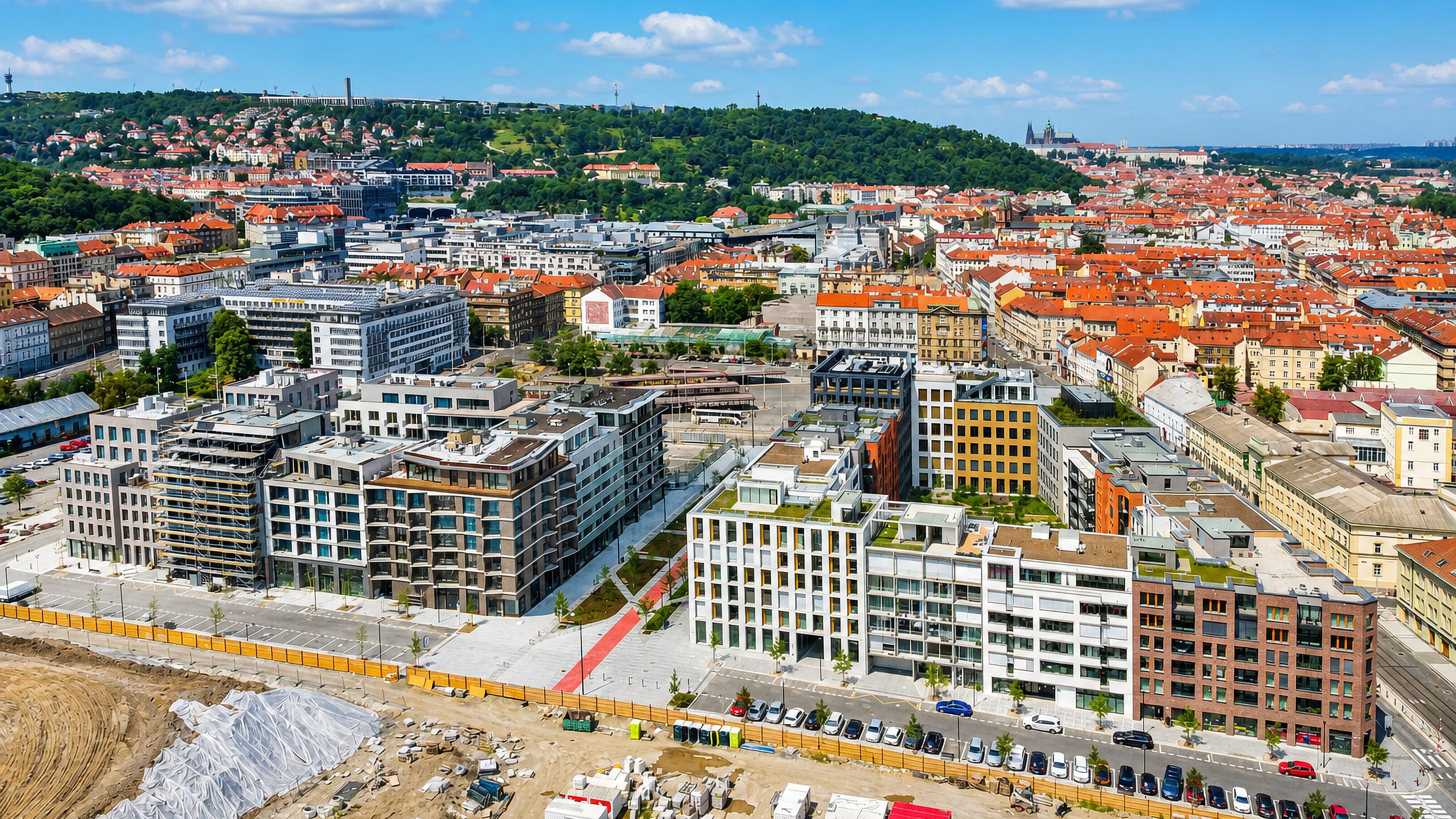 Aerial view of new Smichov development in Prague with Petrin lookout tower and Prague Castle beyond