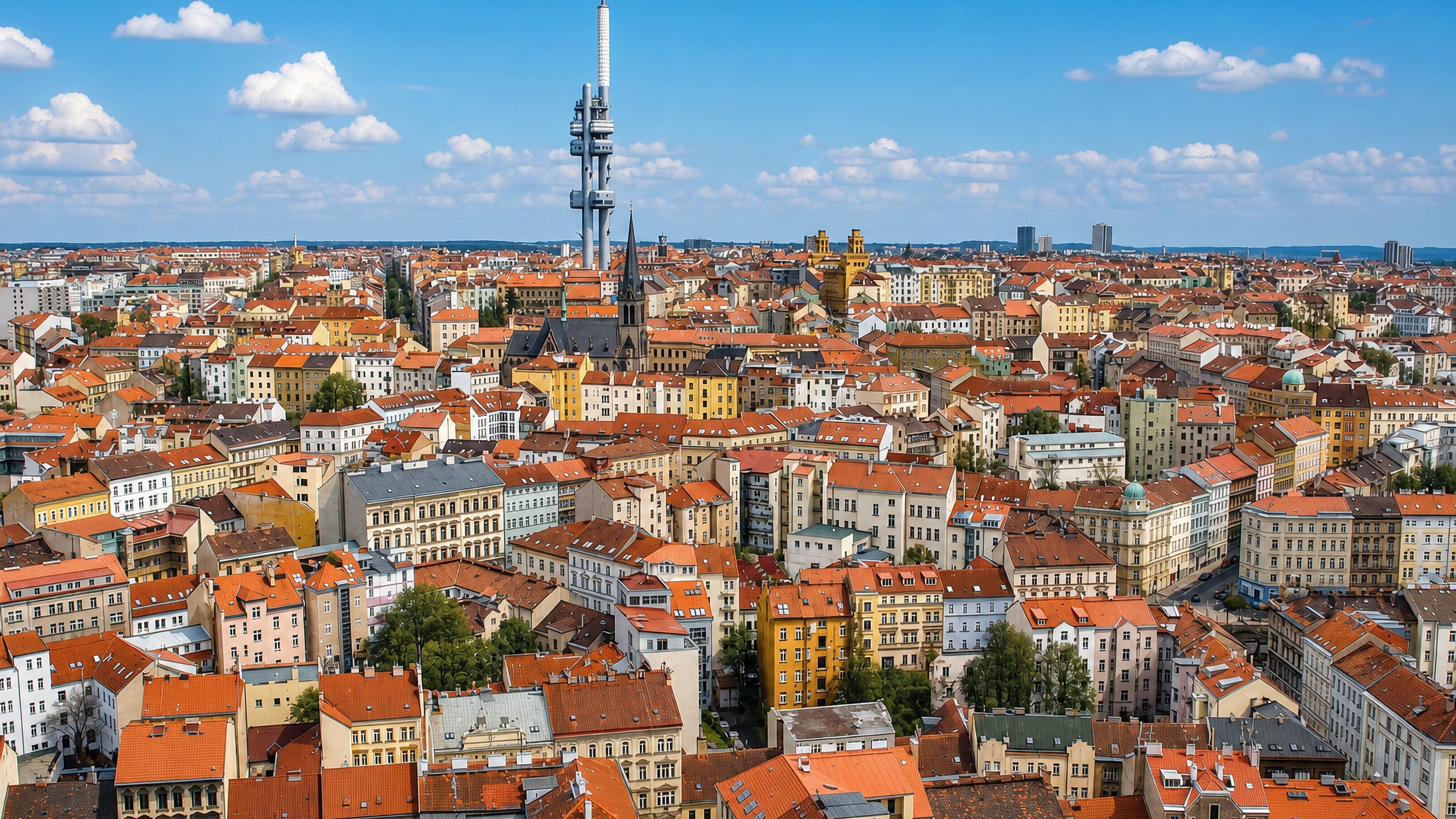 Žižkov Television Tower rising over the red-tiled rooftops of the Žižkov district in Prague