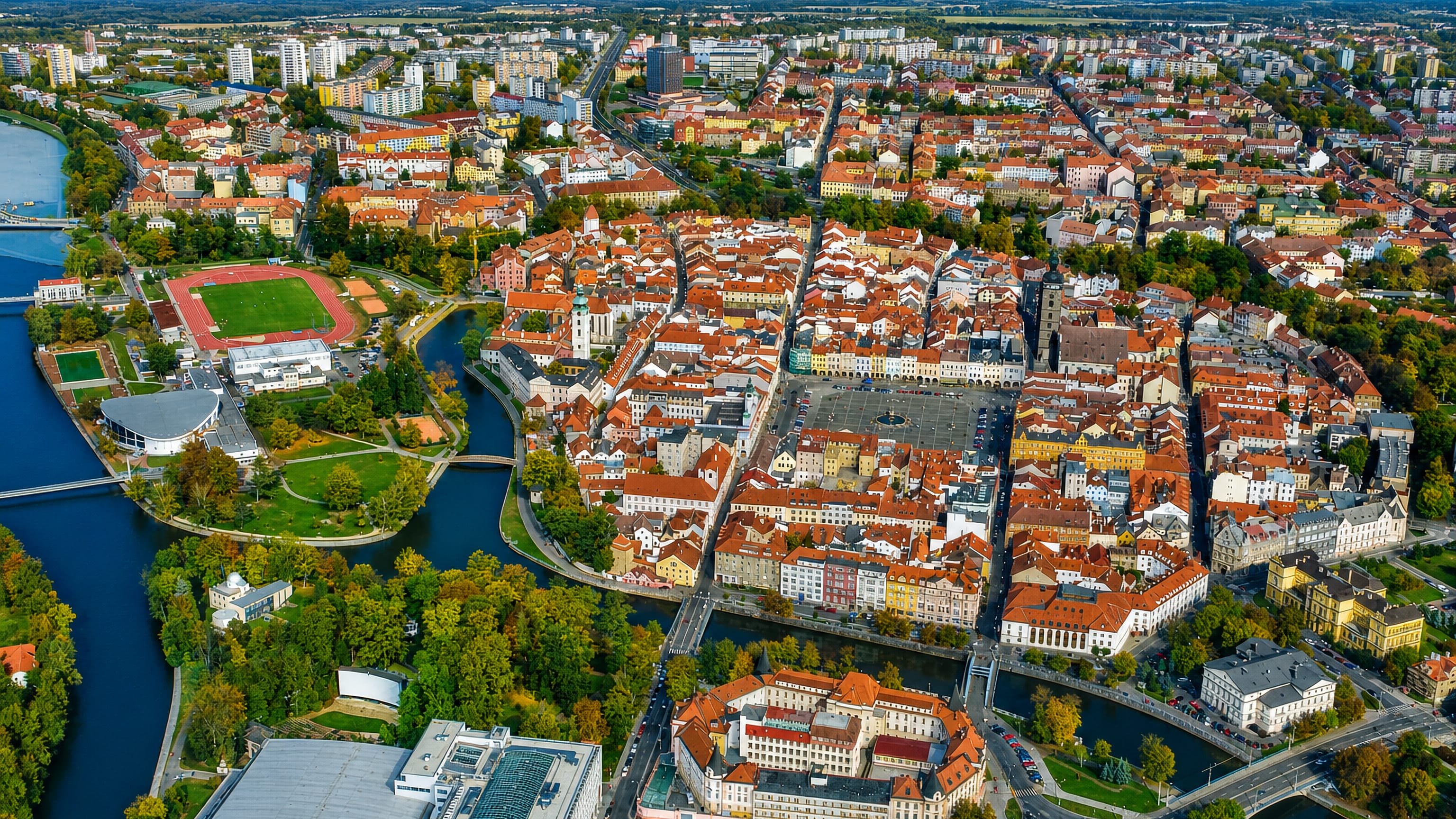 Aerial view of Ceske Budejovice's old town around its vast main square, Black Tower and encircling rivers.