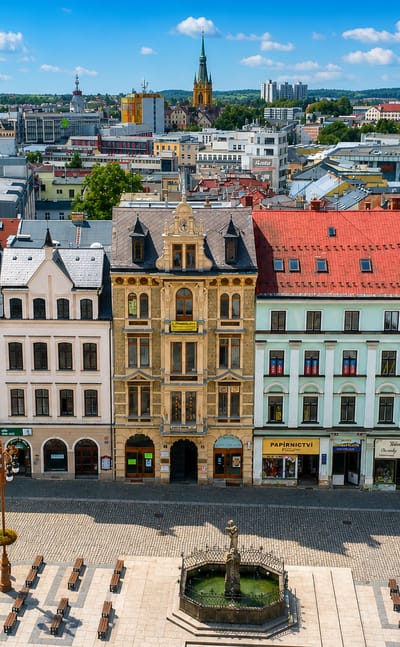 Colourful baroque townhouses and a fountain lining a cobbled square in Liberec, Czech Republic.