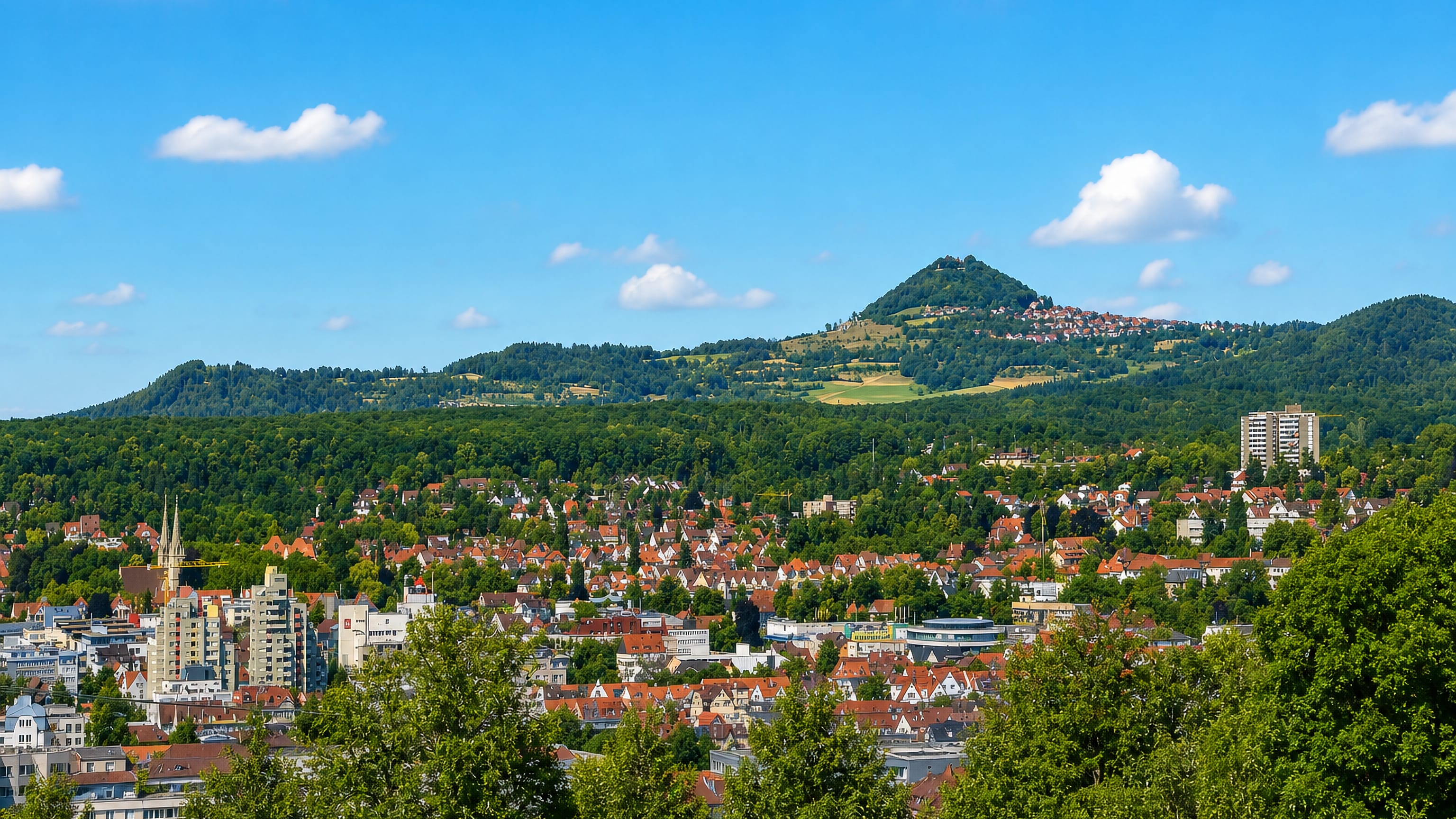Goppingen's red-roofed townscape in Baden-Wurttemberg beneath the conical Hohenstaufen hill.