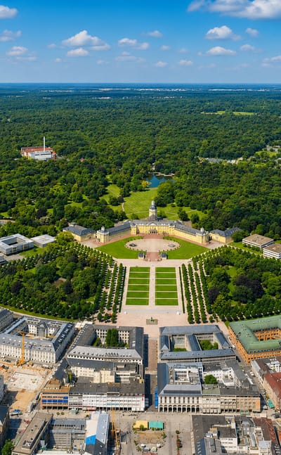 Aerial of Karlsruhe's radial fan layout with the baroque palace at the centre and avenues fanning into the Hardtwald forest