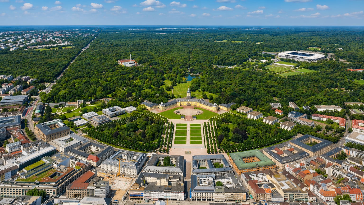 Aerial of Karlsruhe's radial fan layout with the baroque palace at the centre and avenues fanning into the Hardtwald forest
