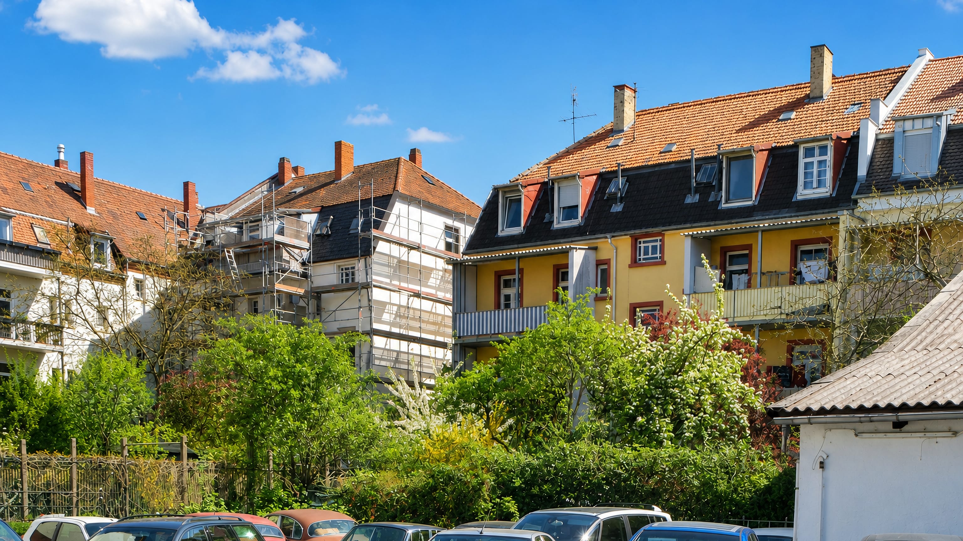Tiled roofs and balconies of apartment houses above a parking area in Südweststadt, Karlsruhe.