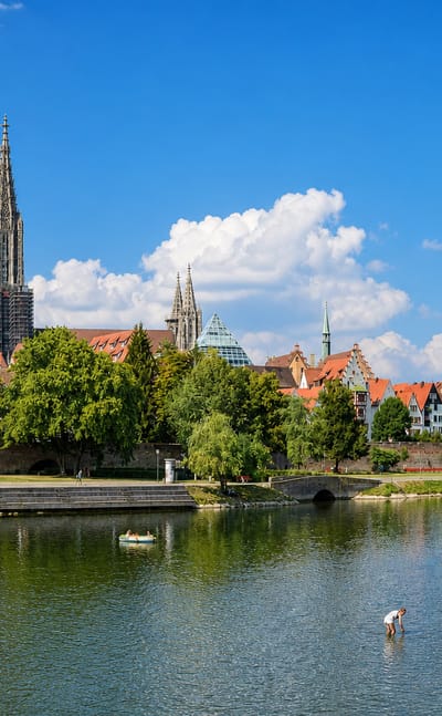 Ulm Minster's spire soaring over the old town's red roofs along the Danube in southern Germany.