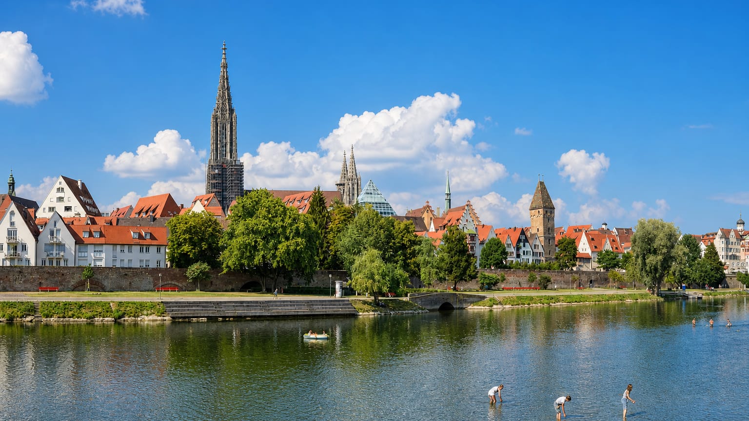 Ulm Minster's spire soaring over the old town's red roofs along the Danube in southern Germany.