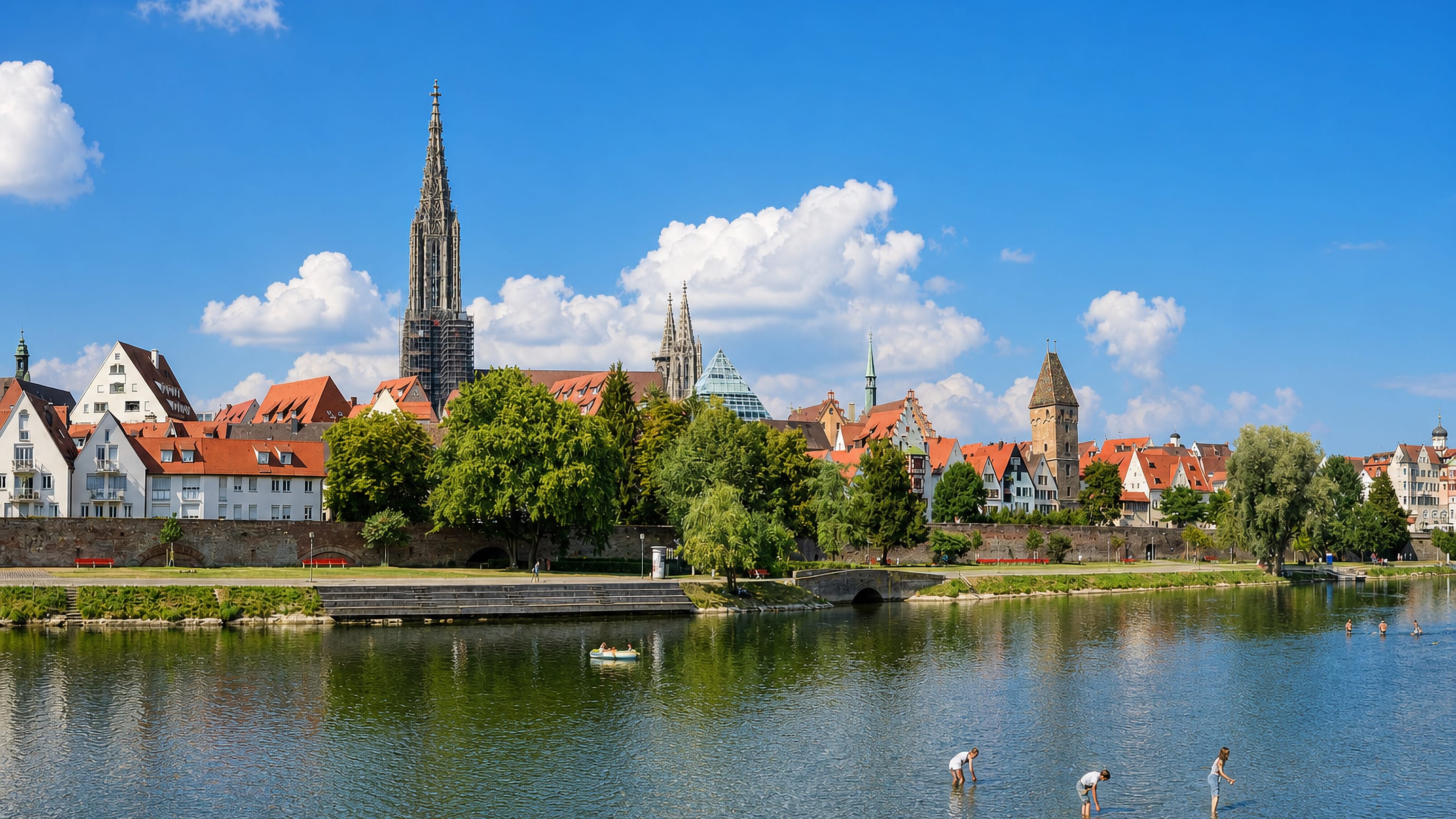 Ulm Minster's spire soaring over the old town's red roofs along the Danube in southern Germany.