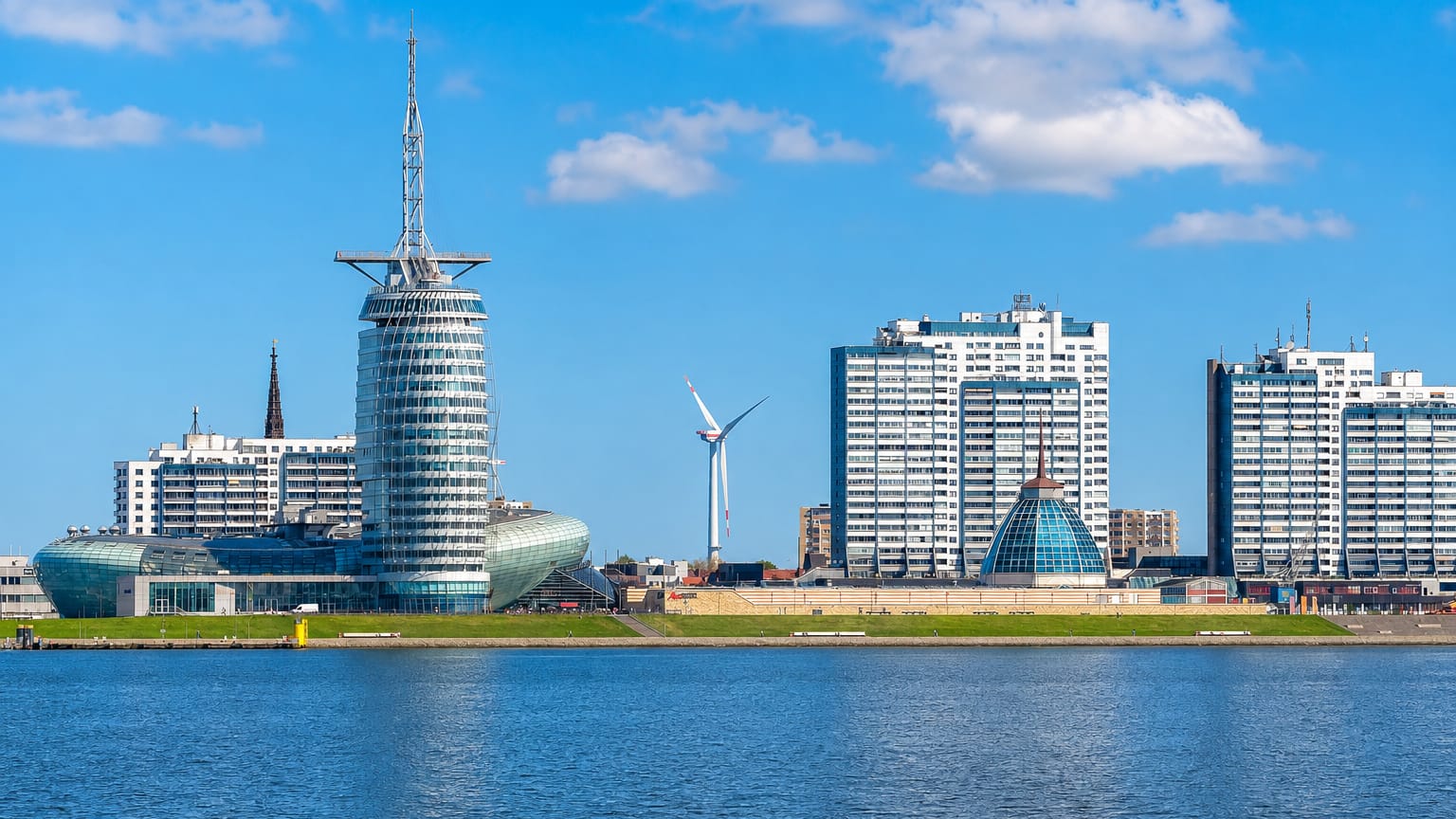 Bremerhaven's Havenwelten waterfront with the Sail City tower, Klimahaus pod and harbour high-rises under blue sky