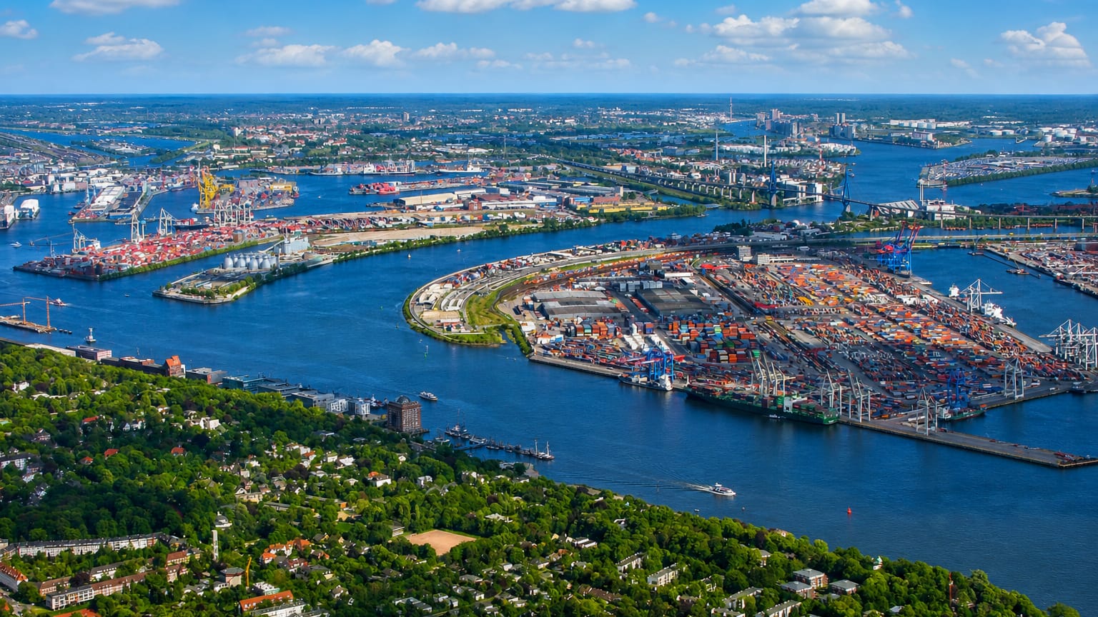 Aerial view over the Elbe from Othmarschen, leafy Hamburg riverside suburb facing the container port and harbour cranes